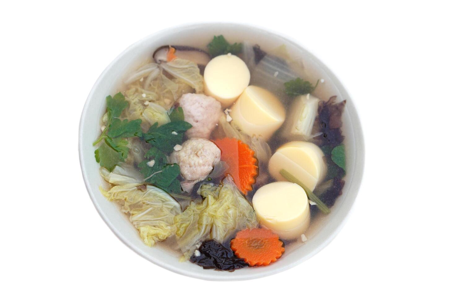 Bowl of homemade clear soup with egg tofu, seaweed and vegetables, isolated on white background. Concept, healthy food. Delicious and popular menu in Thailand. Thai food. photo
