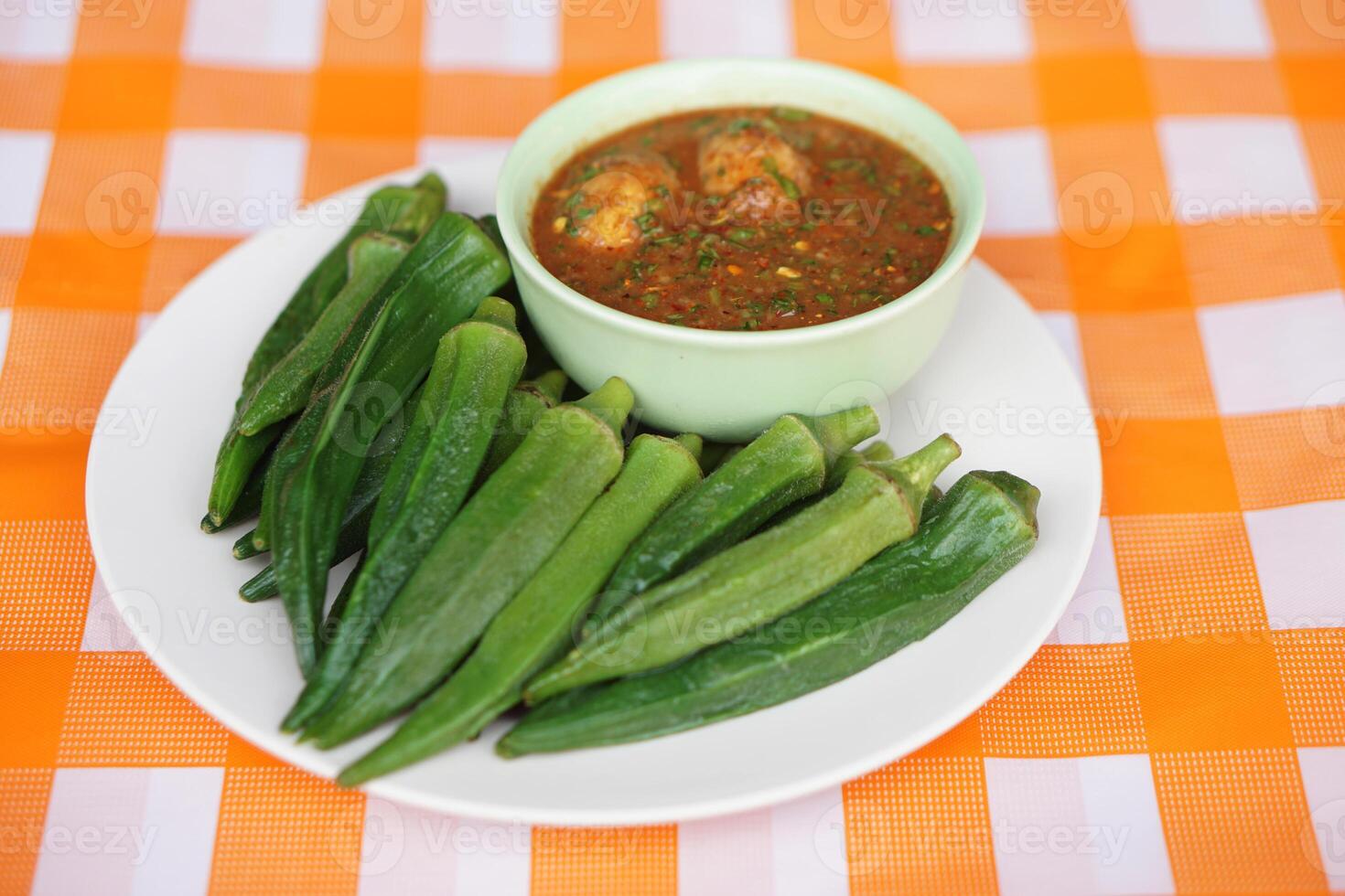 Boiled green okra or lady's finger fruits and chilli paste. Concept healthy food. Delicious menu and good for health with medicinal herbal qualification from local organic fruit and vegetables. photo