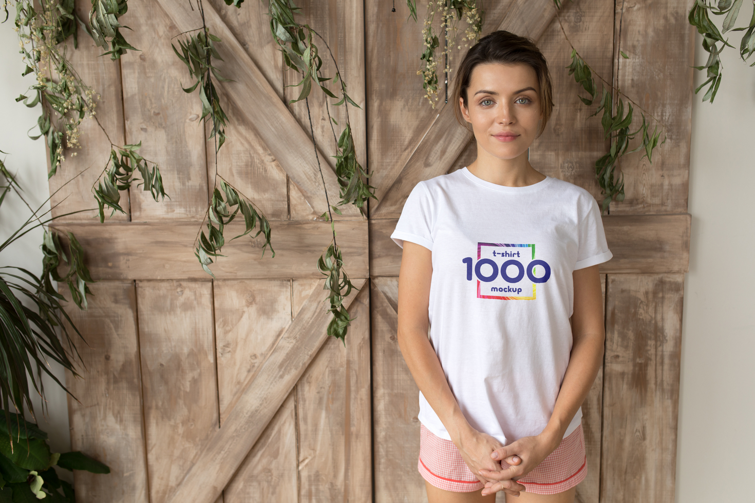 Woman in White T-Shirt Mockup Against Rustic Wooden Door psd