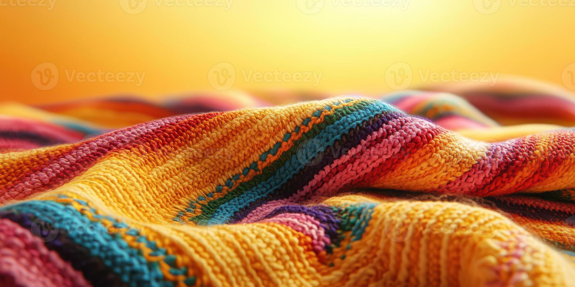 Colorful striped blanket draped gently over a surface with warm lighting in the background during a cozy evening photo