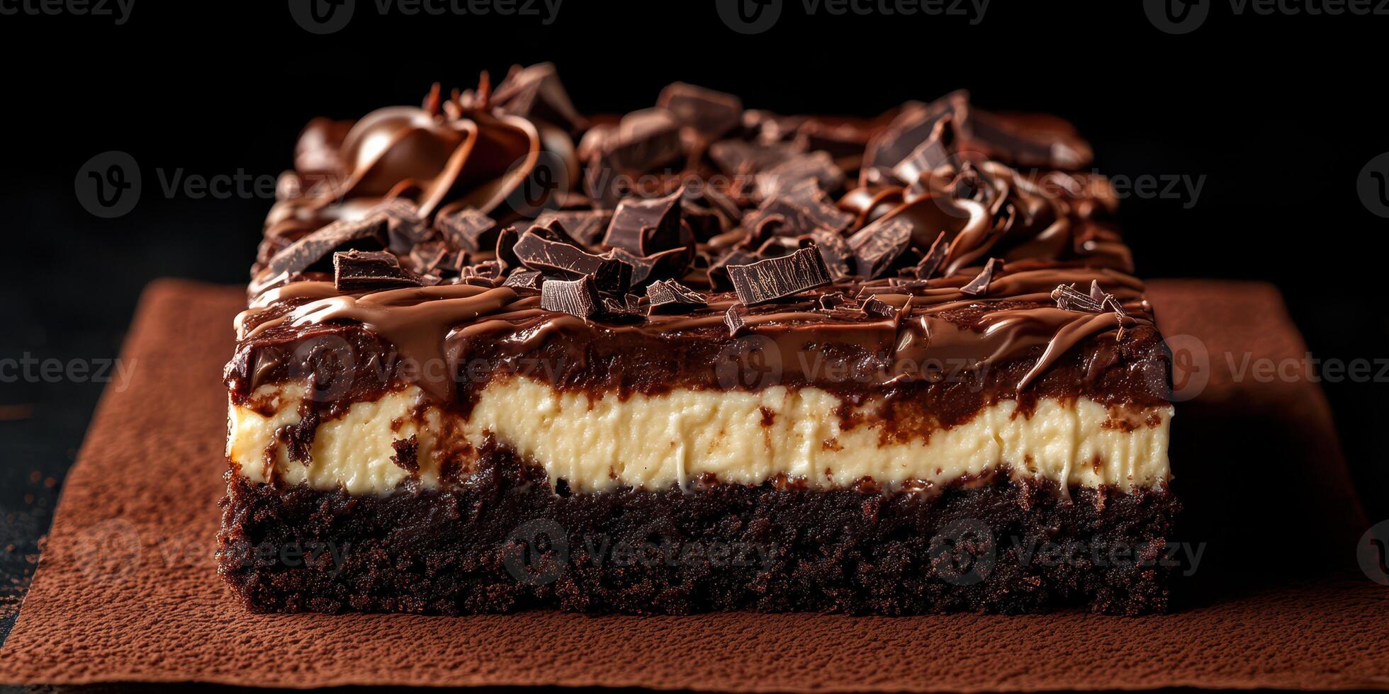 Delicious chocolate cheesecake brownie served on a brown napkin with dark chocolate shavings on top photo