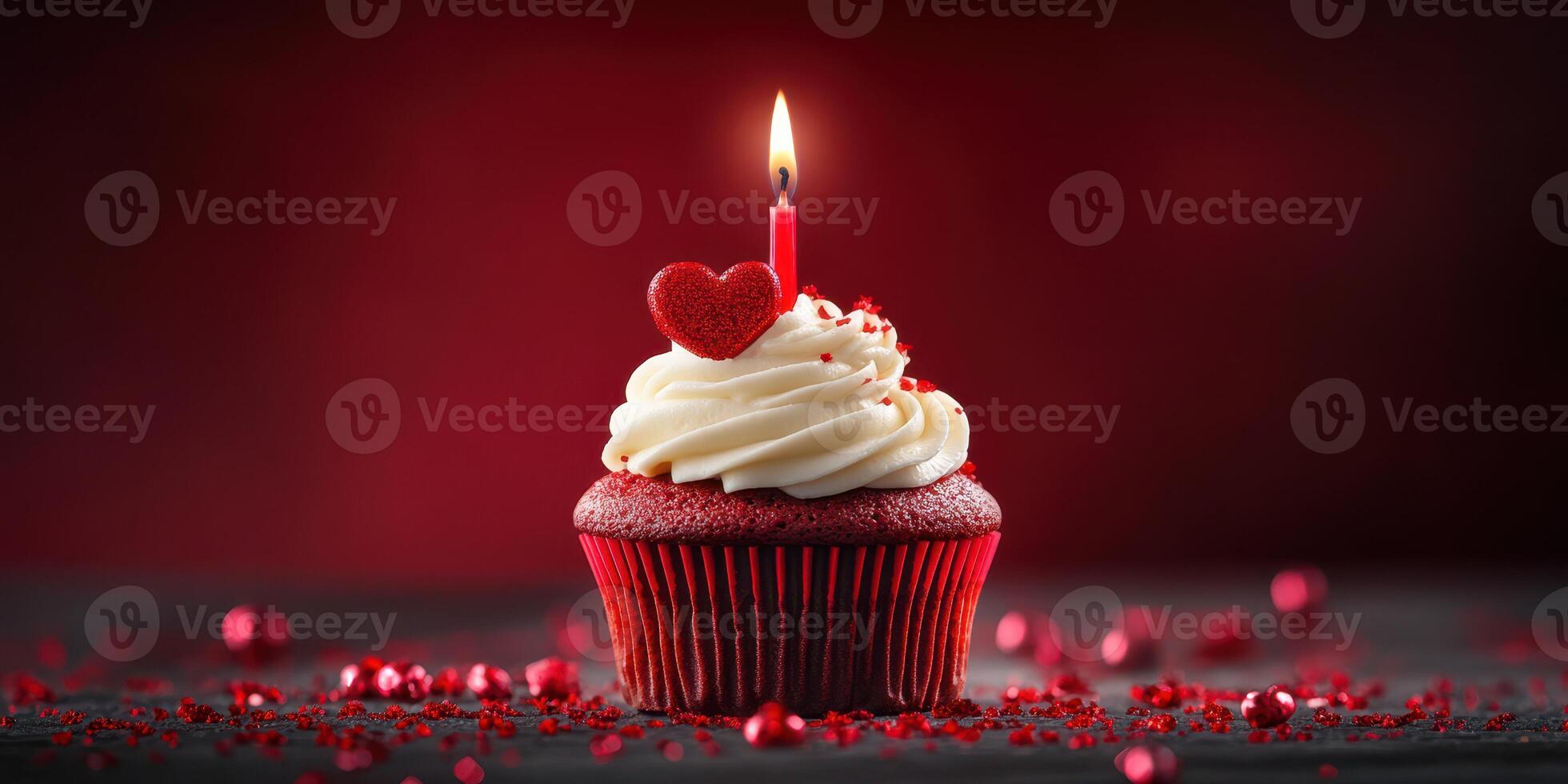 Red velvet cupcake with a heart-shaped decoration and candle on a festive table setting photo