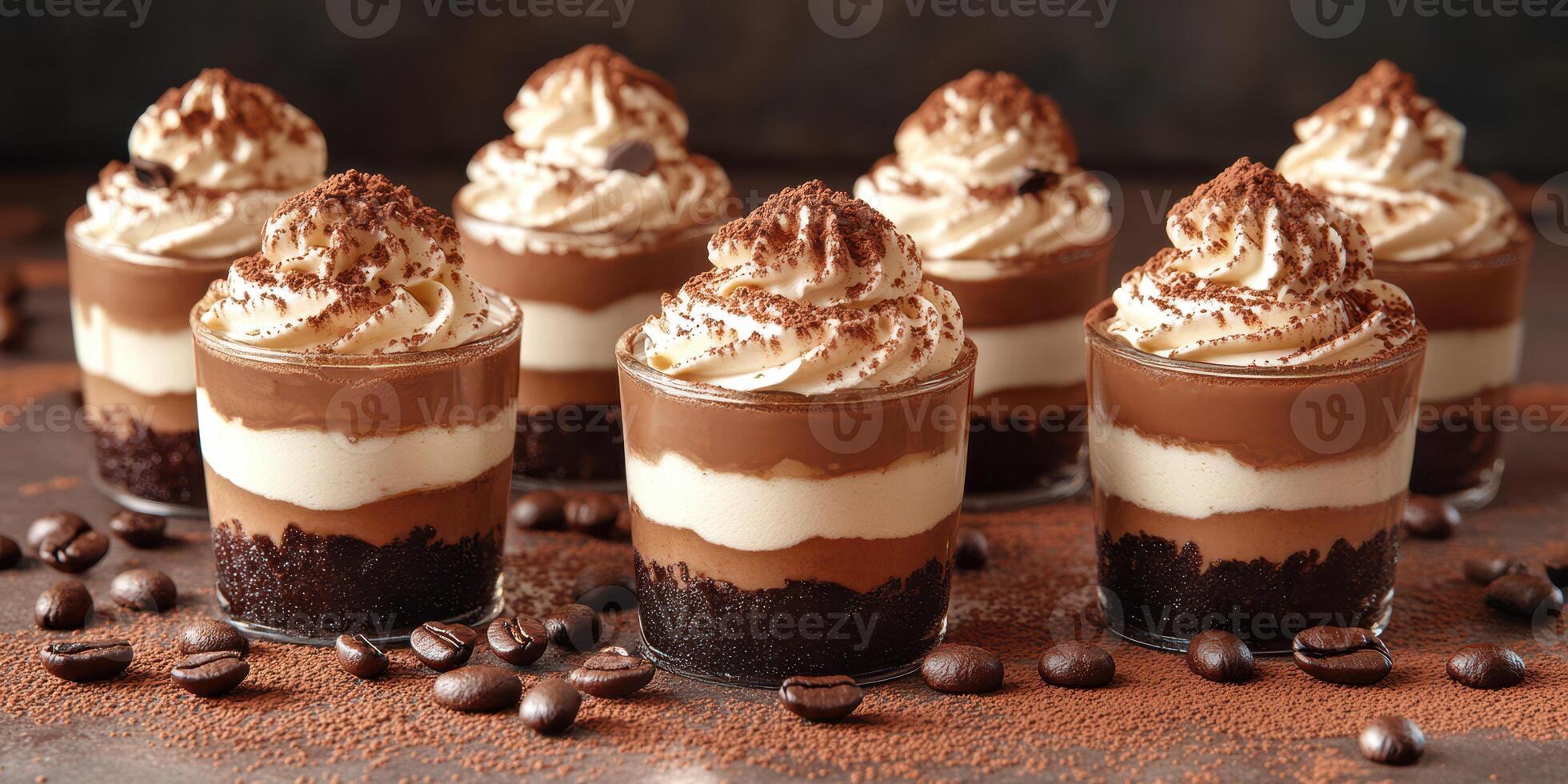 Chocolate dessert cups topped with whipped cream and cocoa served on a dark surface photo