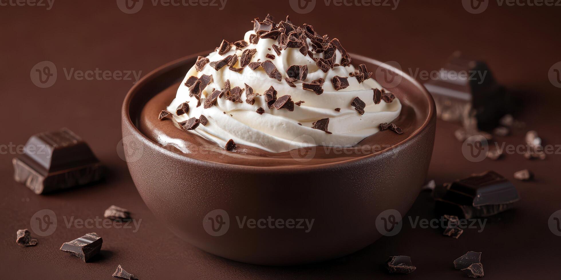 Indulgent chocolate mousse with whipped cream and chocolate shavings garnished in a dark bowl photo