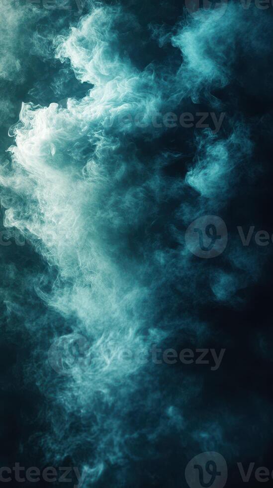 Ethereal turquoise smoke swirling against a dark background creates a mesmerizing visual effect in a dimly lit space photo