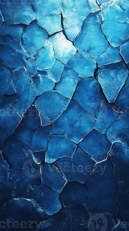 Cracked blue ice surface showcasing intricate patterns and textures in natural light photo