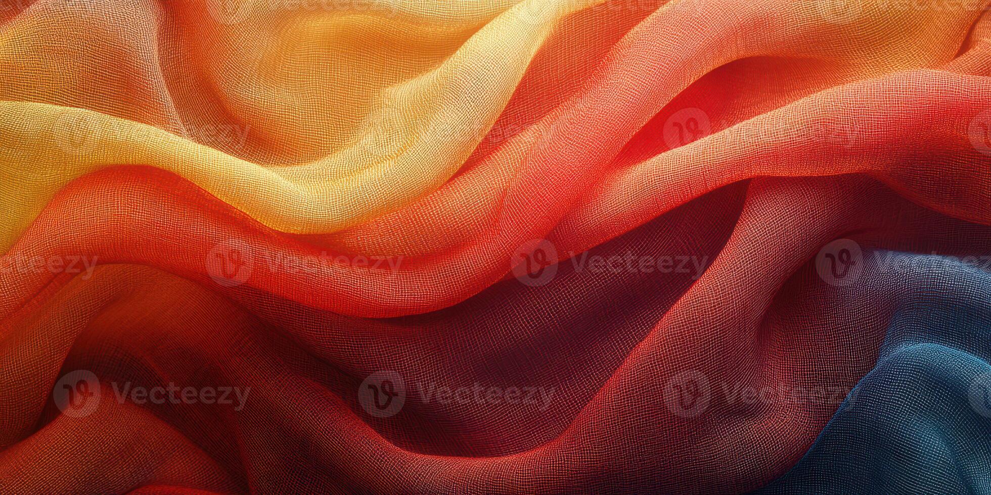 Colorful fabric waves displaying vibrant hues of orange, yellow, and red flowing together in a harmonious pattern photo