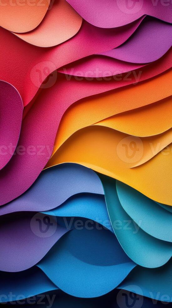 Colorful layered paper waves creating a dynamic visual texture in brilliant hues of red, pink, yellow, blue, and green photo