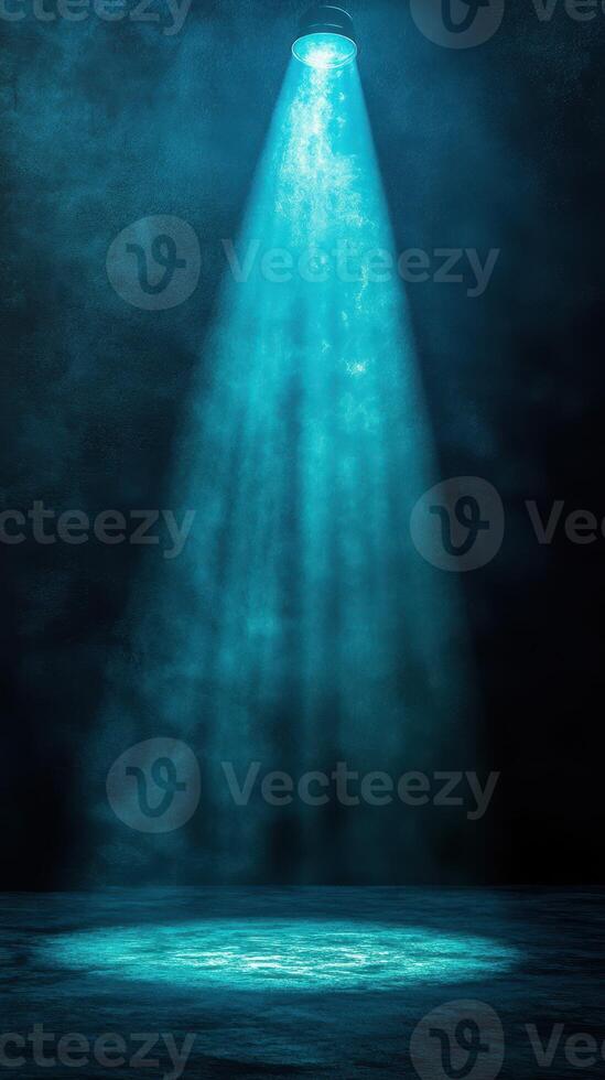 Bright blue spotlight illuminates a dark stage creating a dramatic atmosphere for performance in an indoor venue photo