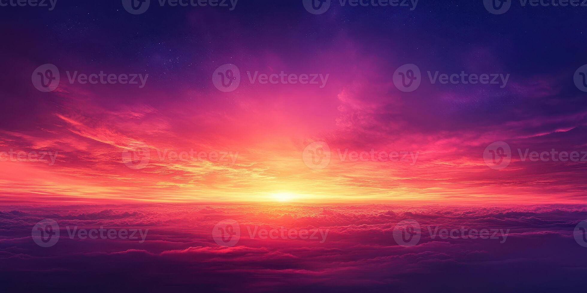 Vibrant sunset colors illuminate the sky over clouds at dusk with shades of pink, purple, and orange blending seamlessly photo