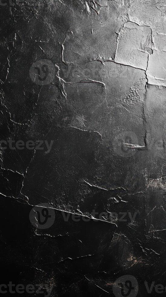 Textured black surface showcasing intricate patterns and shadows in artistic lighting photo