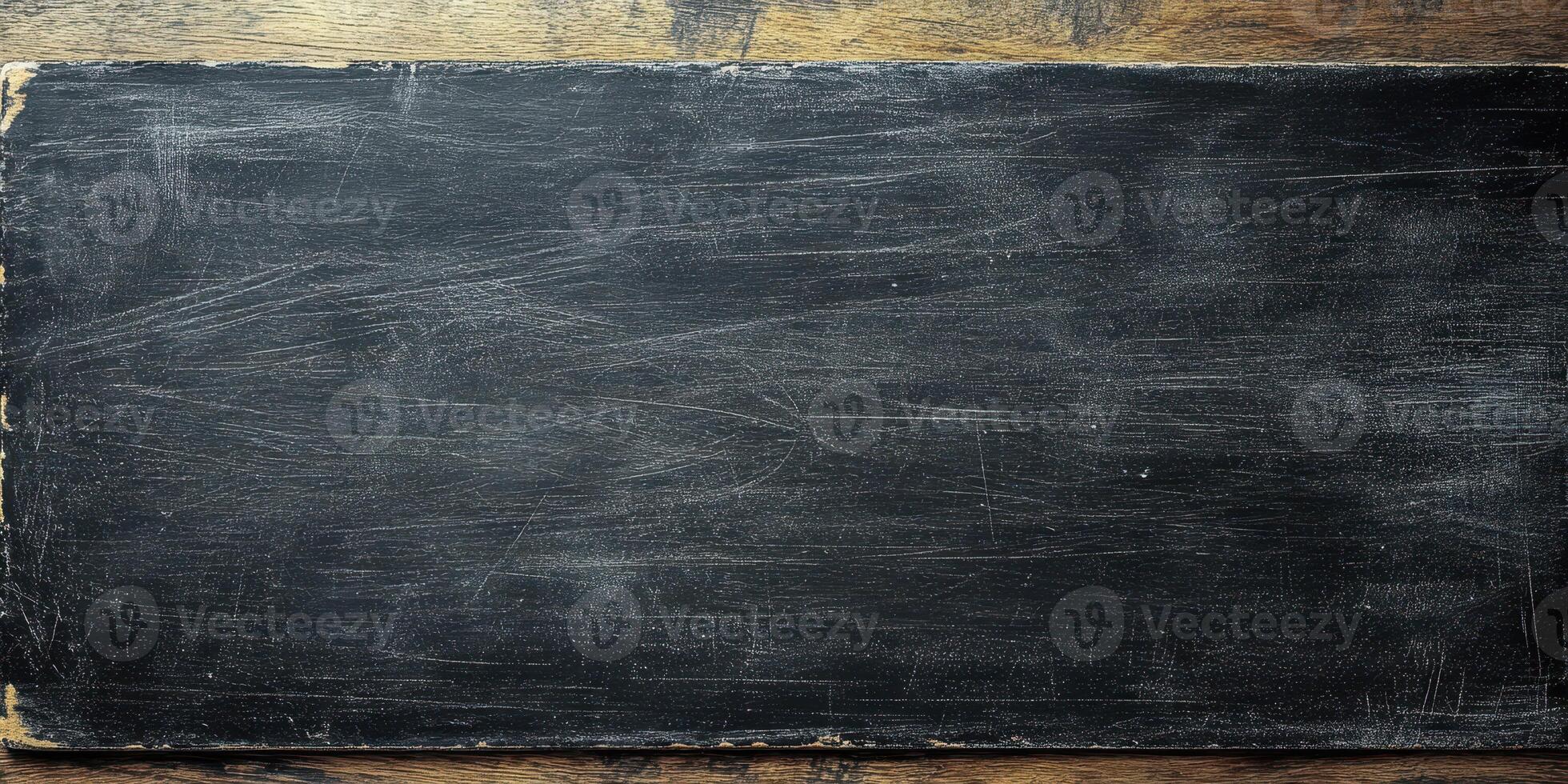 Black chalkboard on wooden surface ready for writing educational content in classroom or cafe environment photo