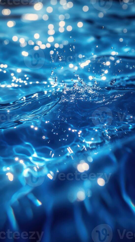 Rippling clear blue water reflecting light with splashes and bubbles during a bright daytime setting photo