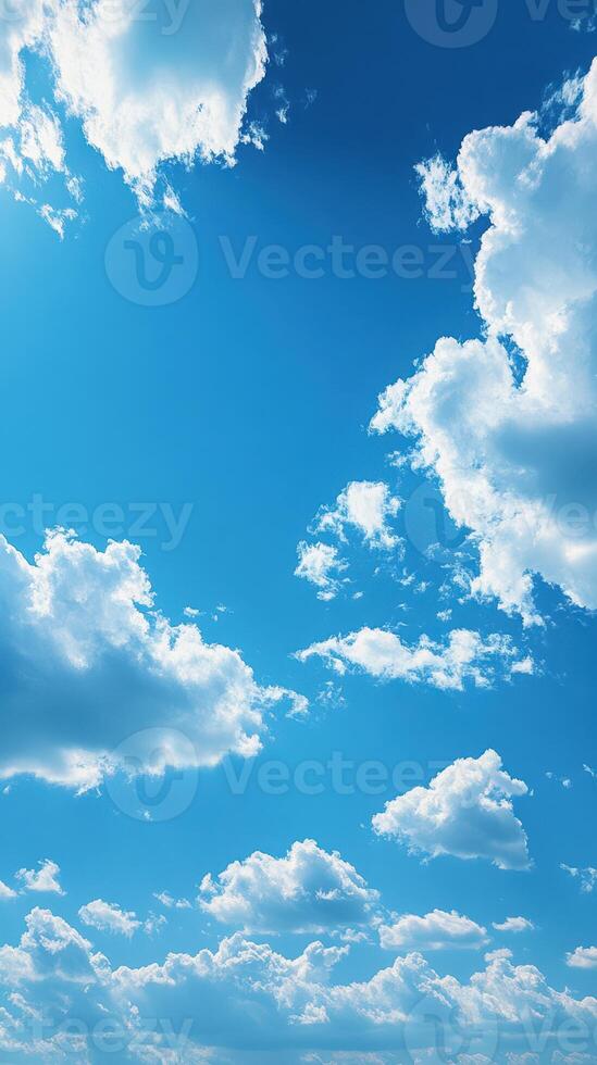 Bright blue sky filled with fluffy clouds during midday in a serene outdoor setting photo