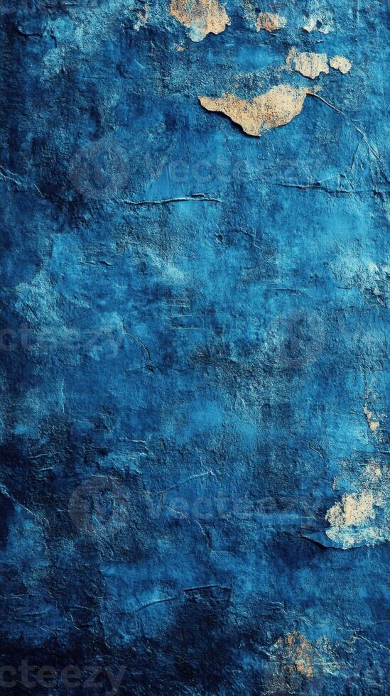 Distressed blue wall with peeling paint showcasing texture and depth in the light photo