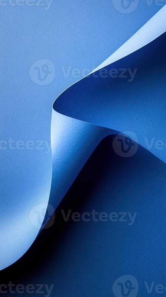 Fluid blue paper curves creating a harmonious design against a dark blue backdrop photo