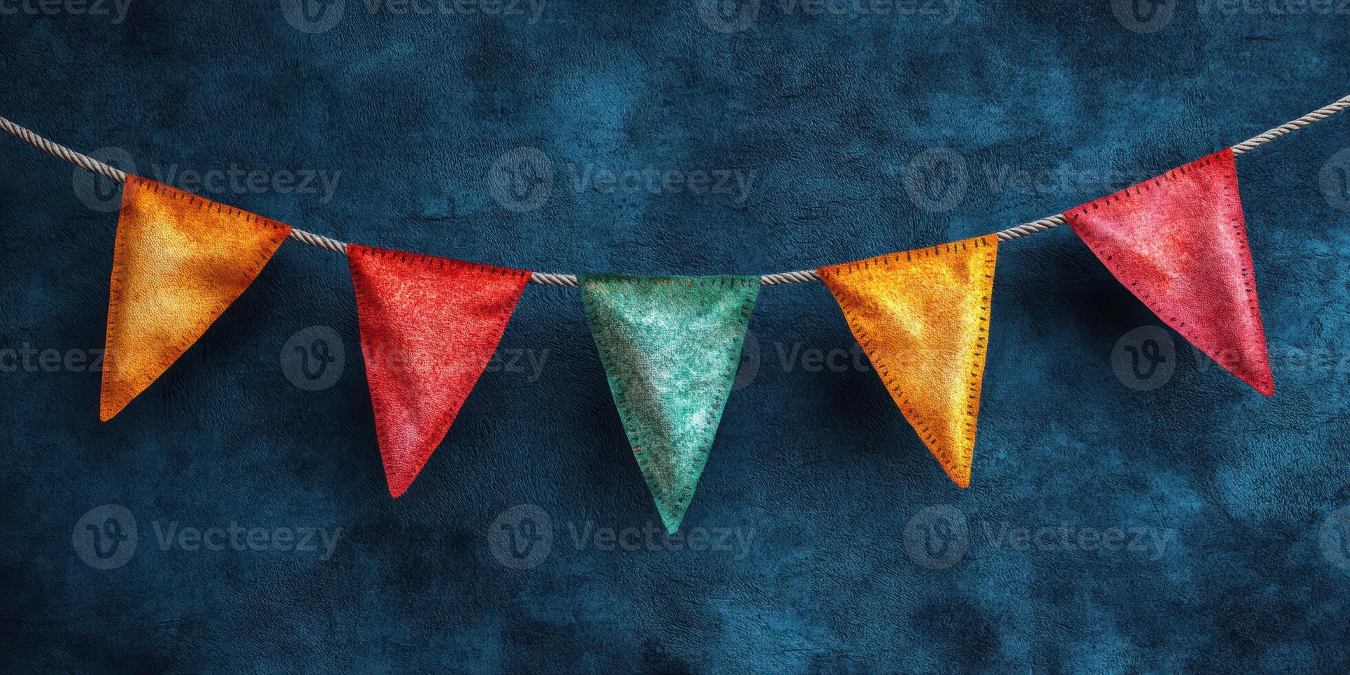 Colorful fabric bunting decorations hanging against a blue textured backdrop for a festive atmosphere photo