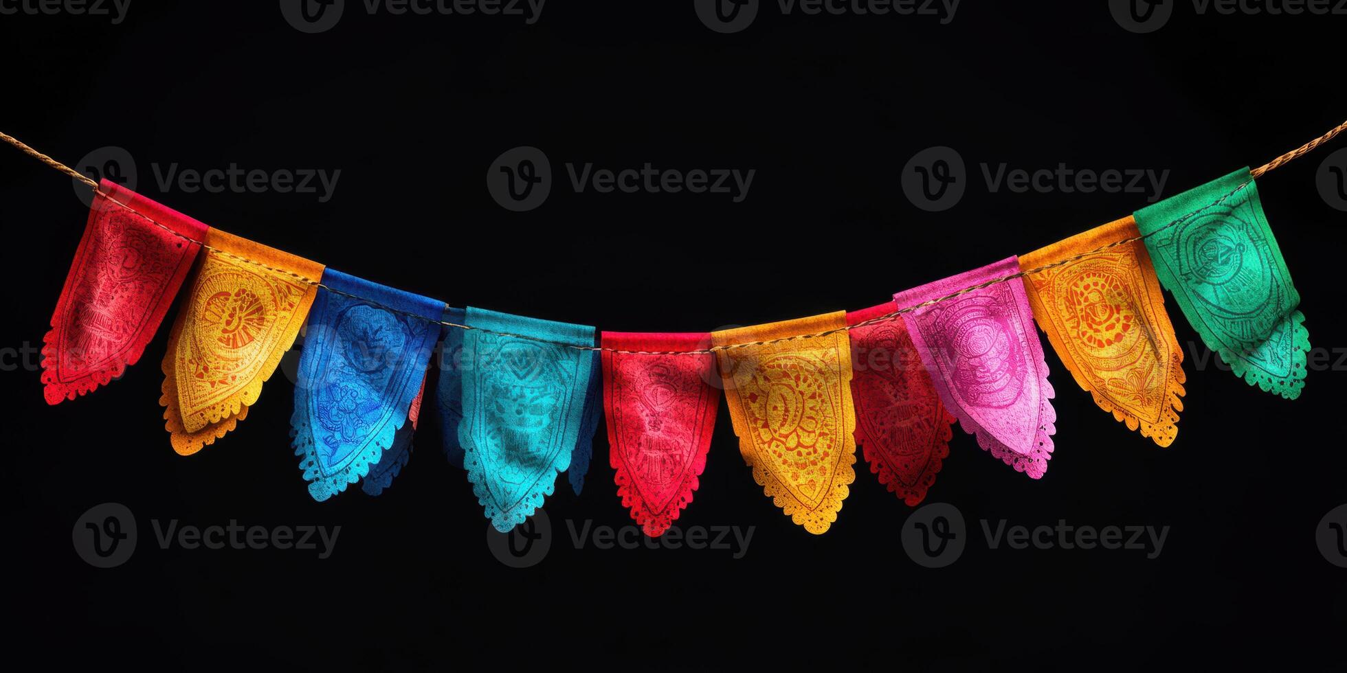 Colorful papel picado banners hanging against a dark background for festive occasions photo