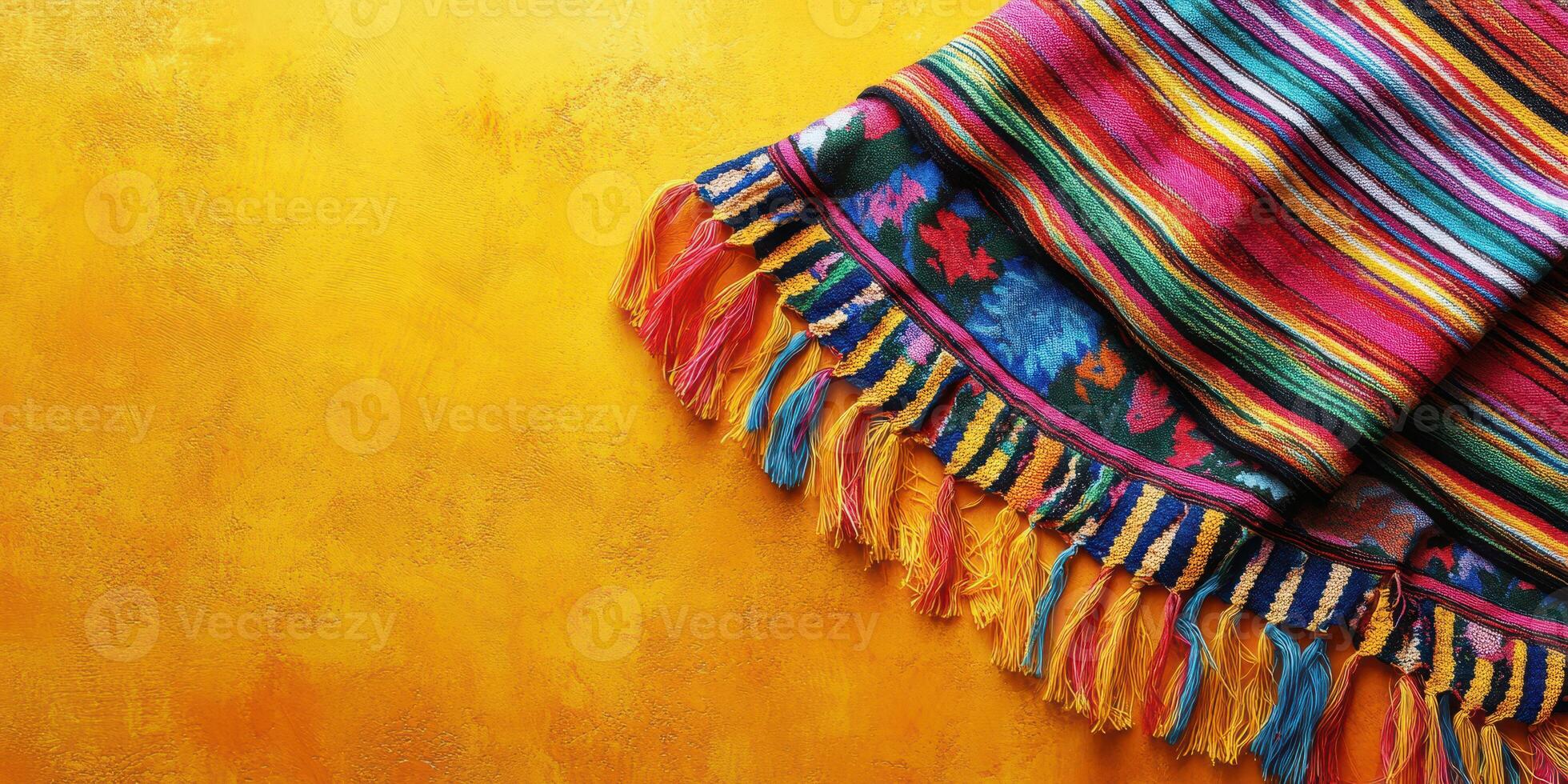 Colorful woven textile with vibrant stripes and fringes against a bright yellow backdrop creating an eye-catching display photo