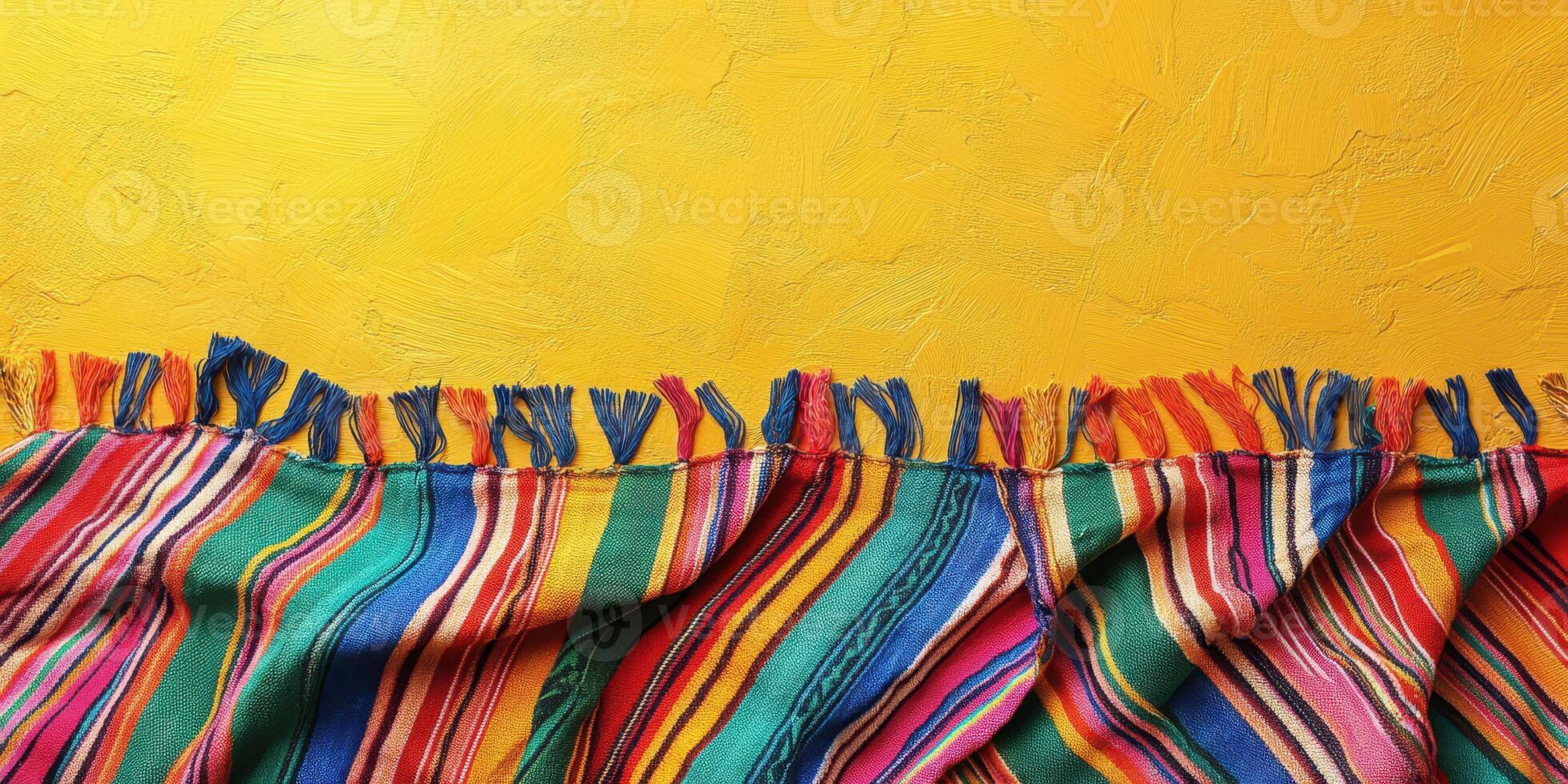 Vibrant textile draped against a warm yellow wall showcasing traditional patterns and colors photo