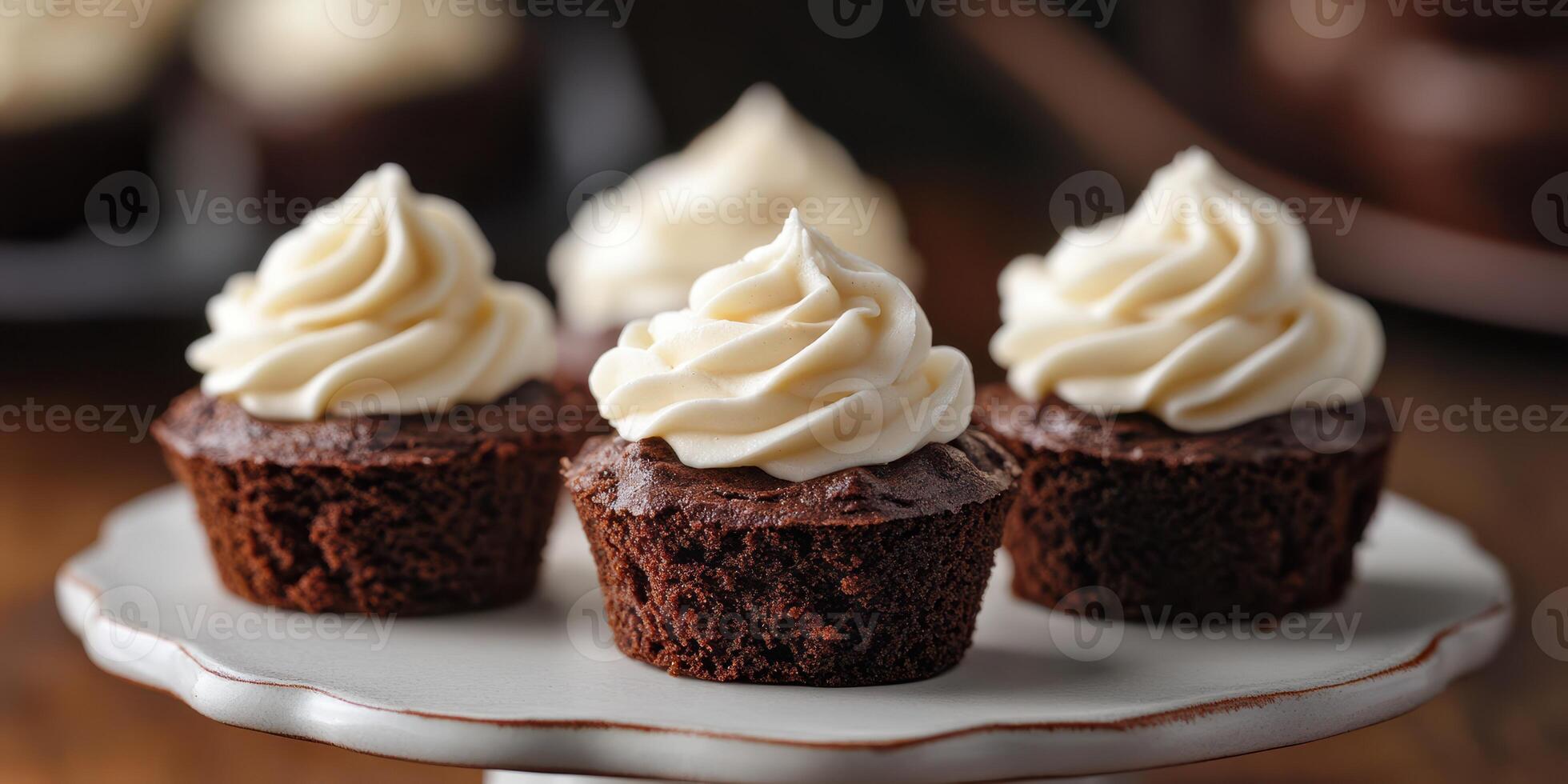 Delicious chocolate cupcakes topped with fluffy cream frosting on a vintage white plate photo