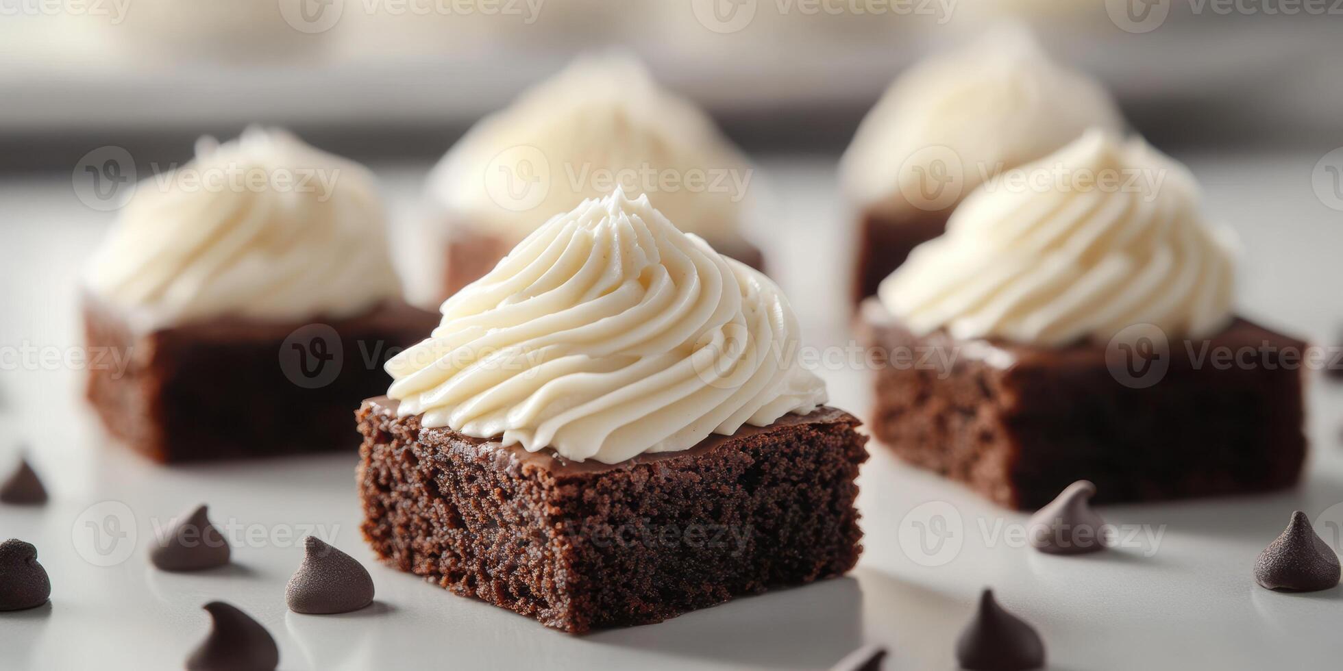 Delicious chocolate brownies topped with creamy frosting on a white dessert table during a baking event photo