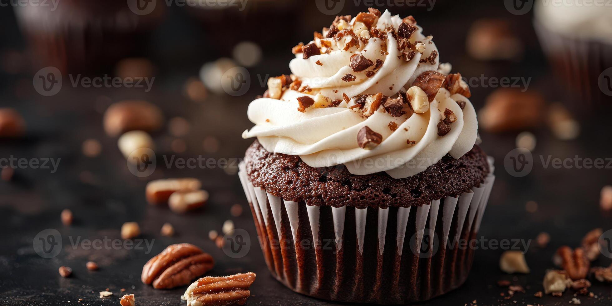 Rich chocolate cupcake topped with creamy frosting and crushed pecans on a dark surface photo