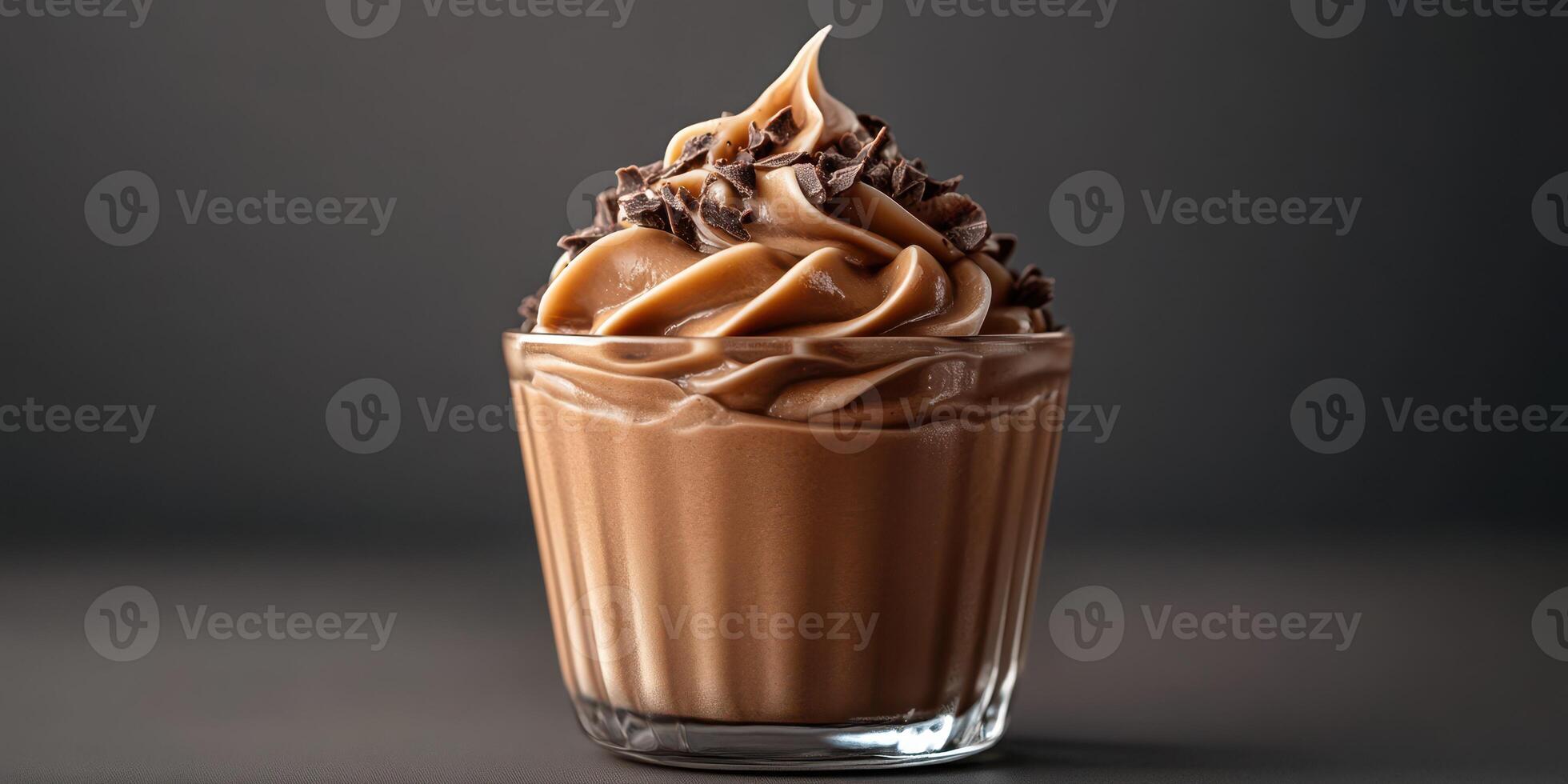 Delicious chocolate mousse topped with chocolate shavings in a clear glass cup photo