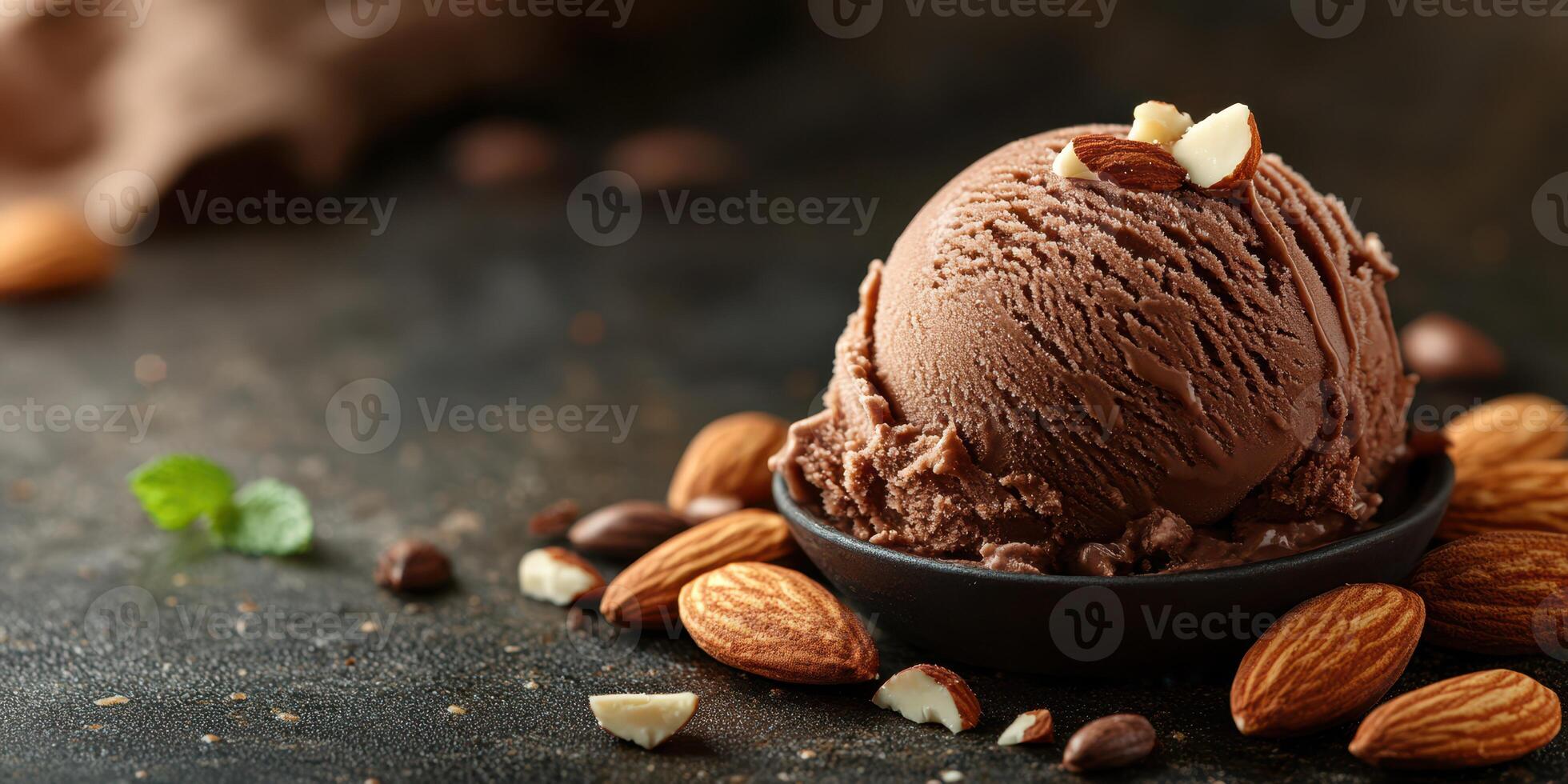Chocolate ice cream scoop served with almonds and mint on a dark background featuring a rustic style photo