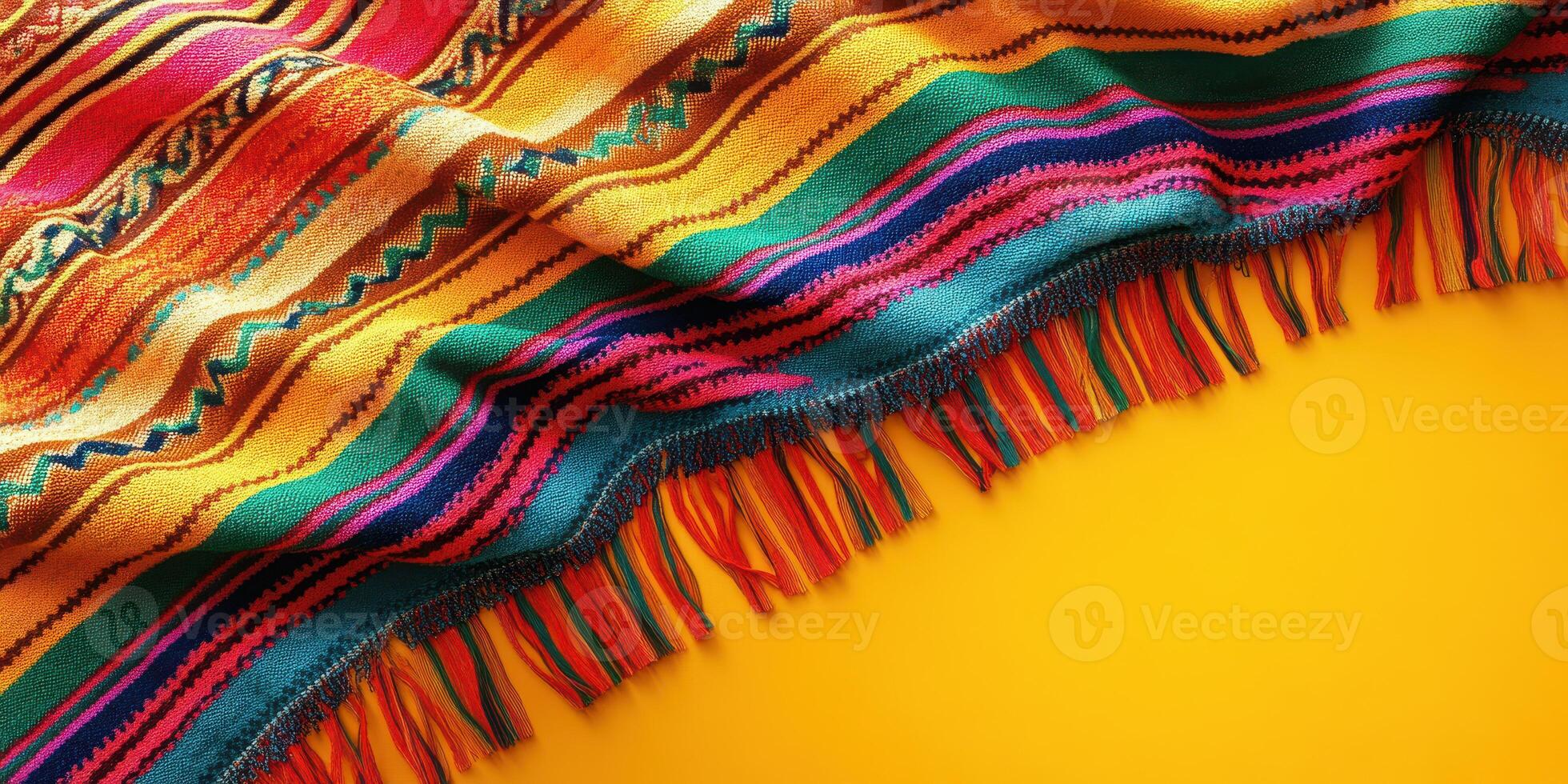 Colorful woven blanket on a bright yellow surface showcasing vibrant patterns and textures, ideal for decorative use photo