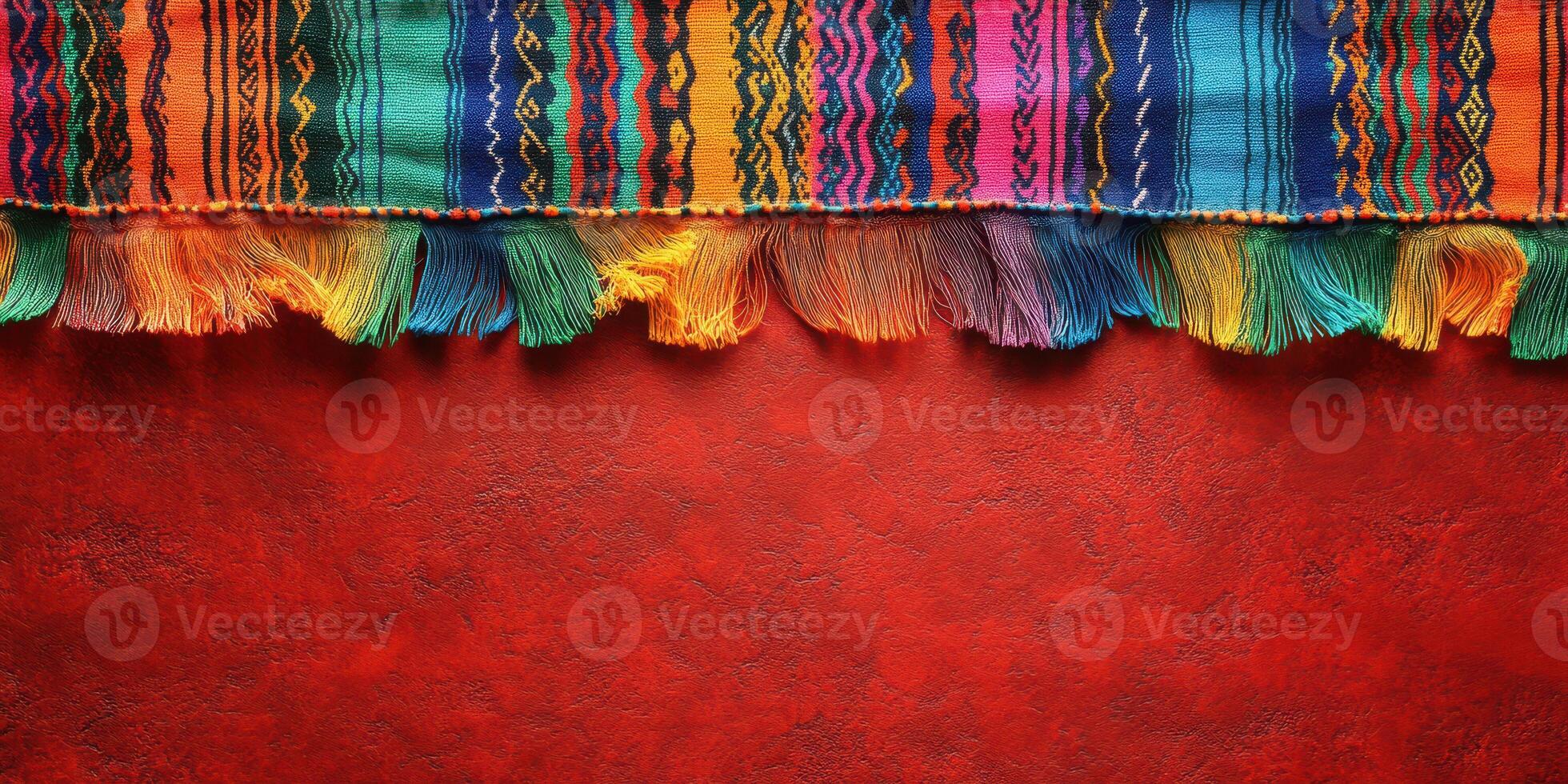 Vibrant textile with colorful fringes against a warm red backdrop creating an inviting atmosphere photo