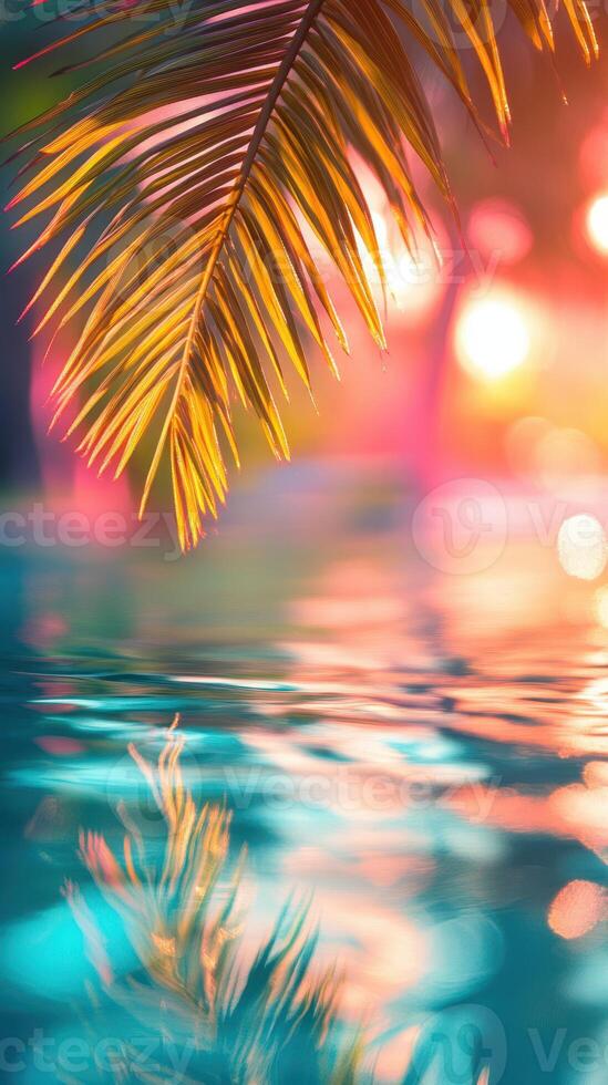 Colorful reflections of palm leaves on tranquil water at sunset near a tropical paradise photo