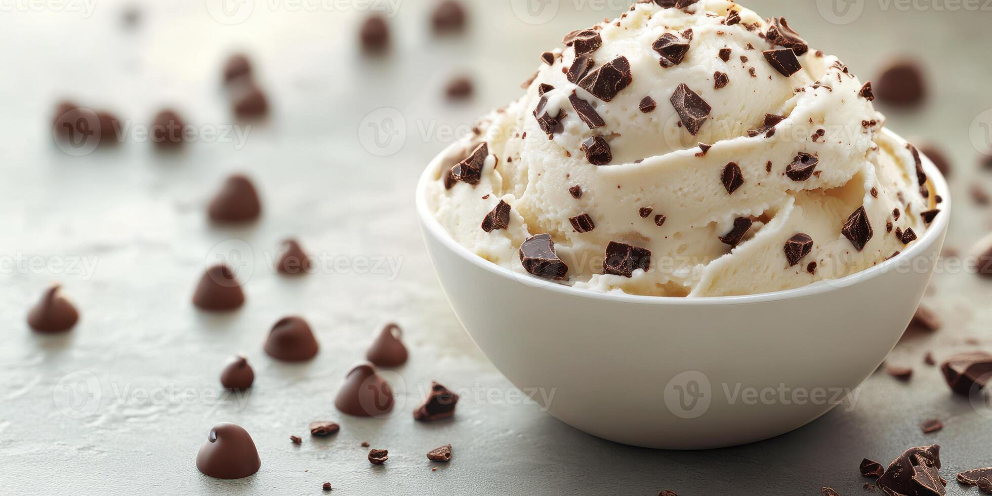 Delicious vanilla ice cream topped with chocolate chips in a white bowl on a textured surface photo