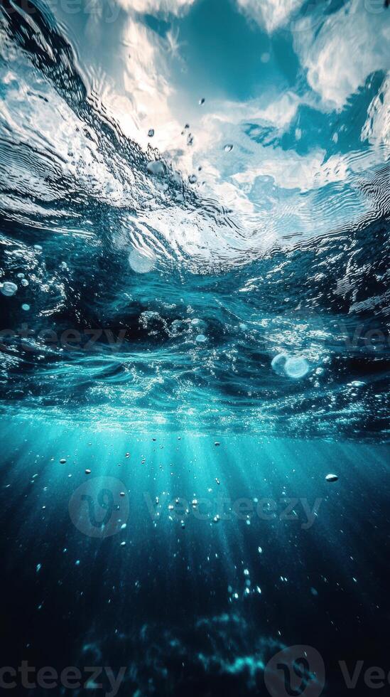Underwater view showcasing sunlight filtering through wavy ocean surface and bubbles rising towards the light photo