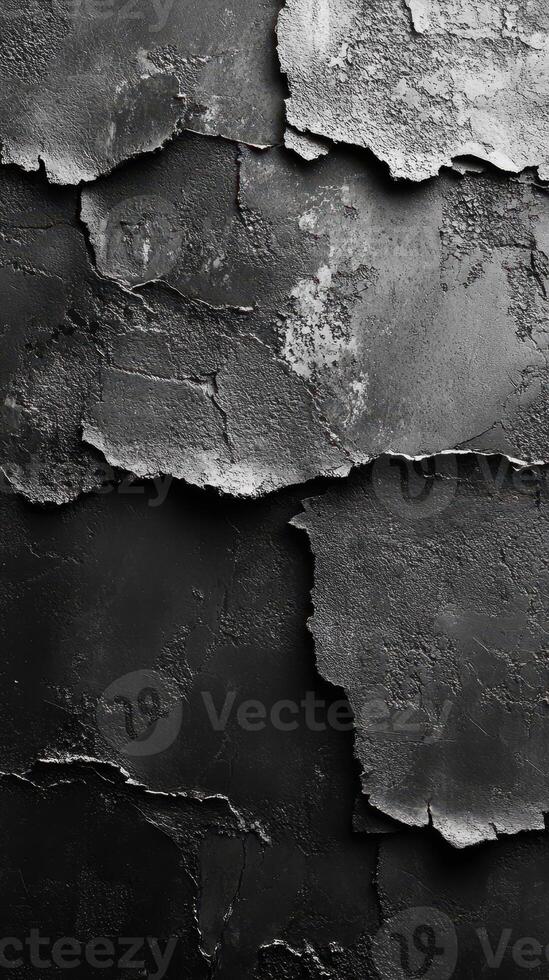 Close-up view of weathered black and grey textured surface with peeling layers revealing different patterns photo