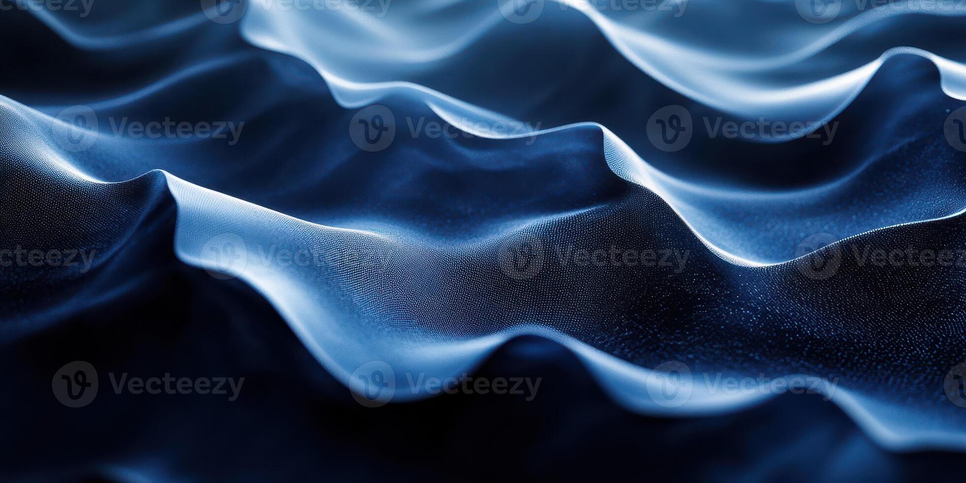 Flowing waves of blue fabric create an elegant texture in soft light, conveying a sense of fluidity and movement photo