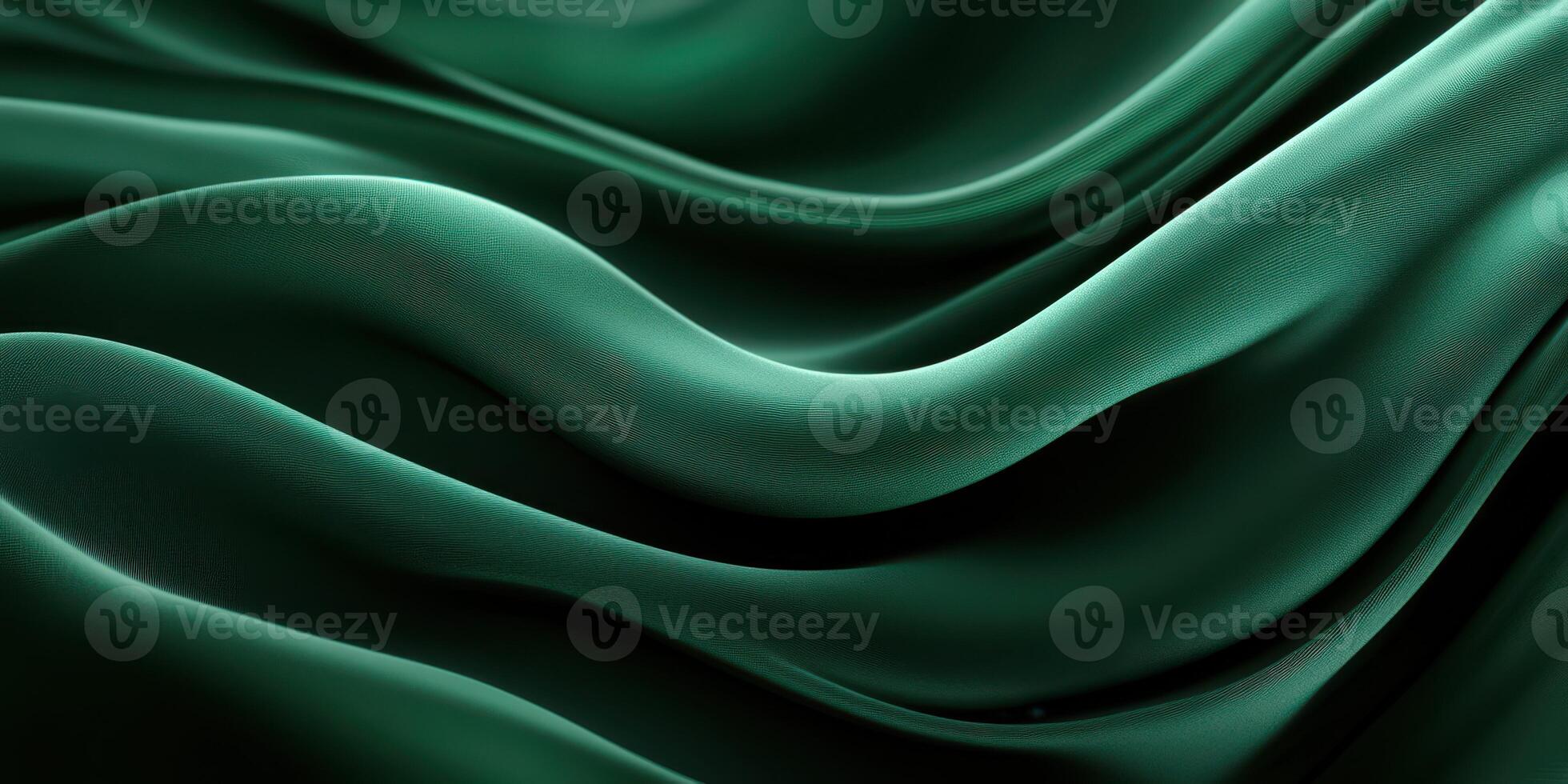 Elegant folds of deep green fabric create waves of texture and movement in a soft lighting setting photo
