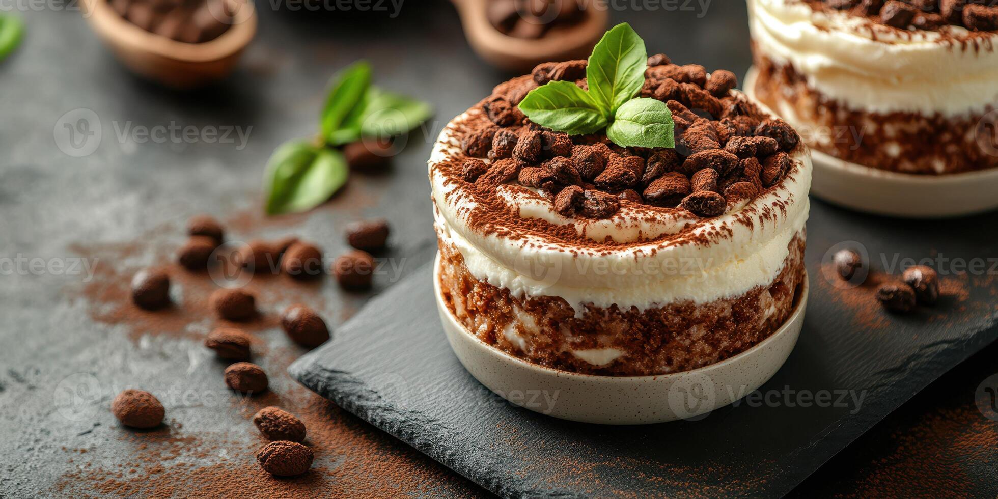 Delicious dessert made with layers of cream, cocoa, and coffee beans on a dark countertop photo