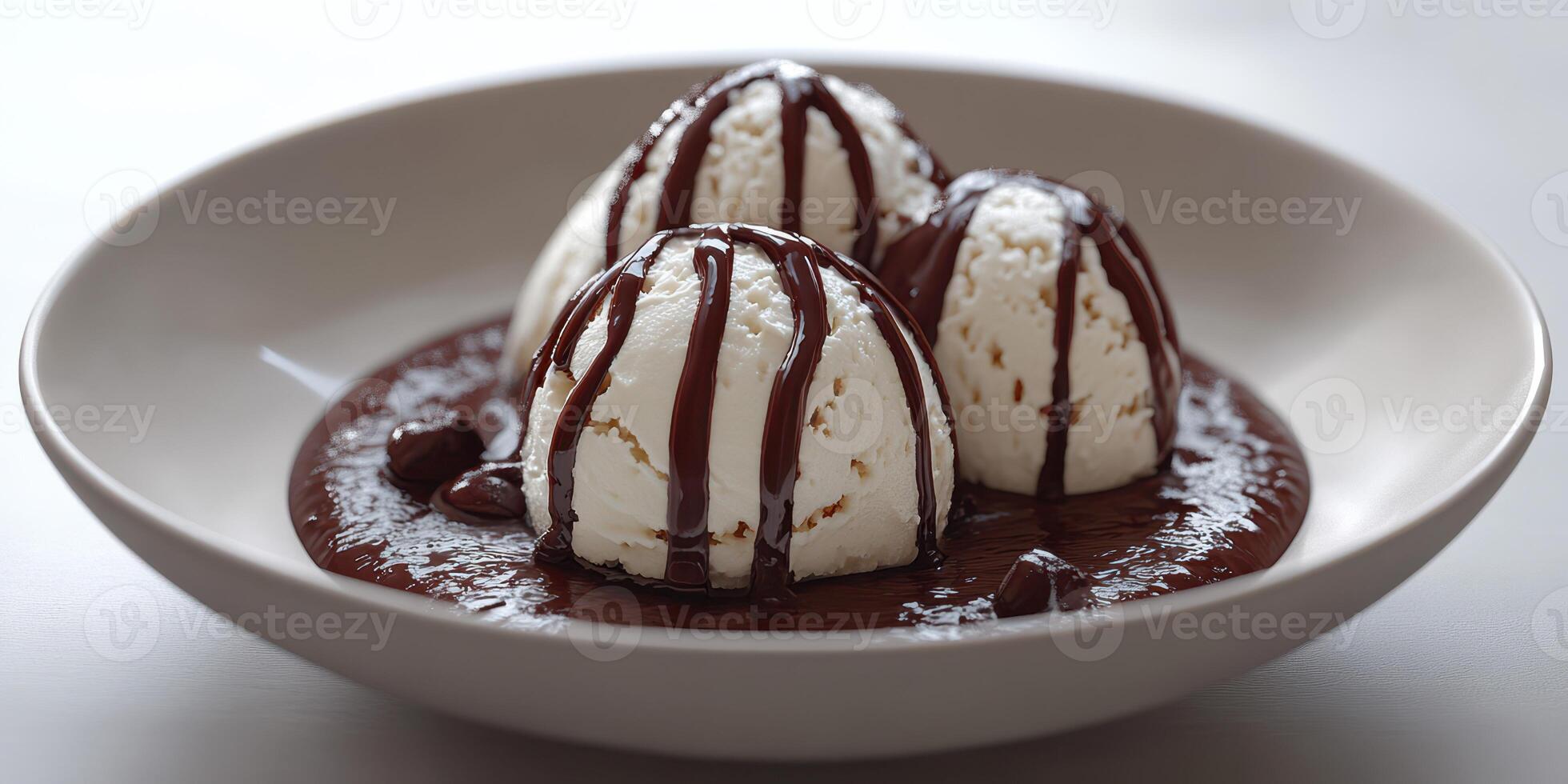 Indulging in a dessert bowl of three scoops of vanilla ice cream topped with rich chocolate sauce photo