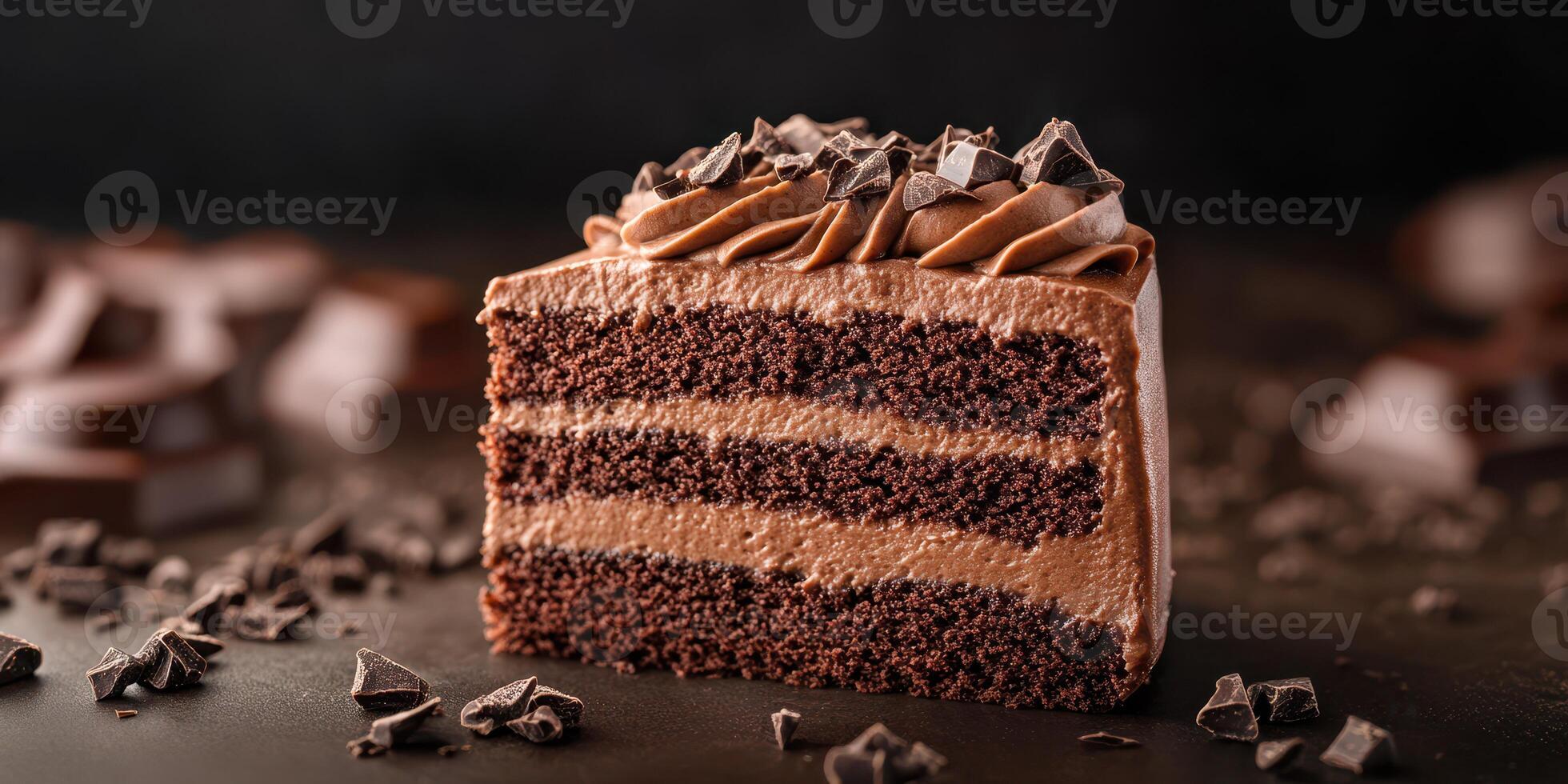 Rich chocolate layer cake with decadent frosting and chocolate shavings on black background photo