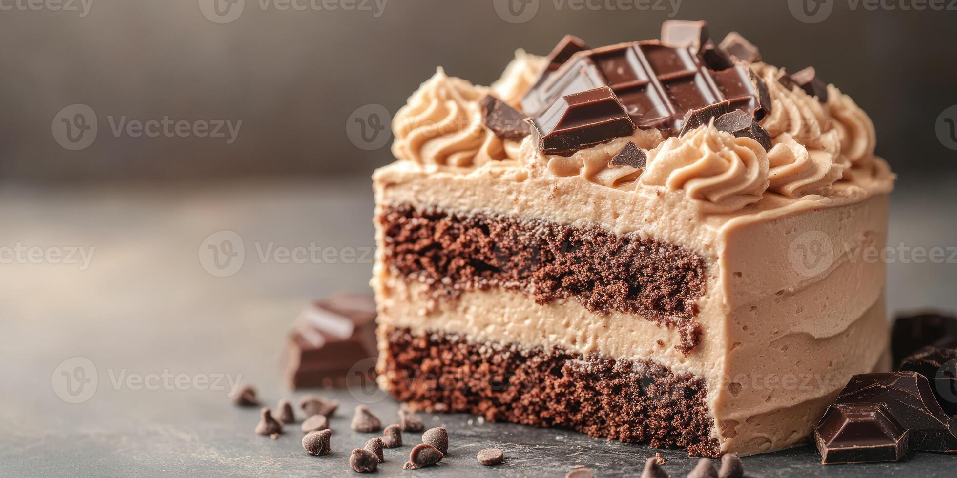 Chocolate cake slice with rich frosting and chocolate pieces on a dark background in a cozy setting photo