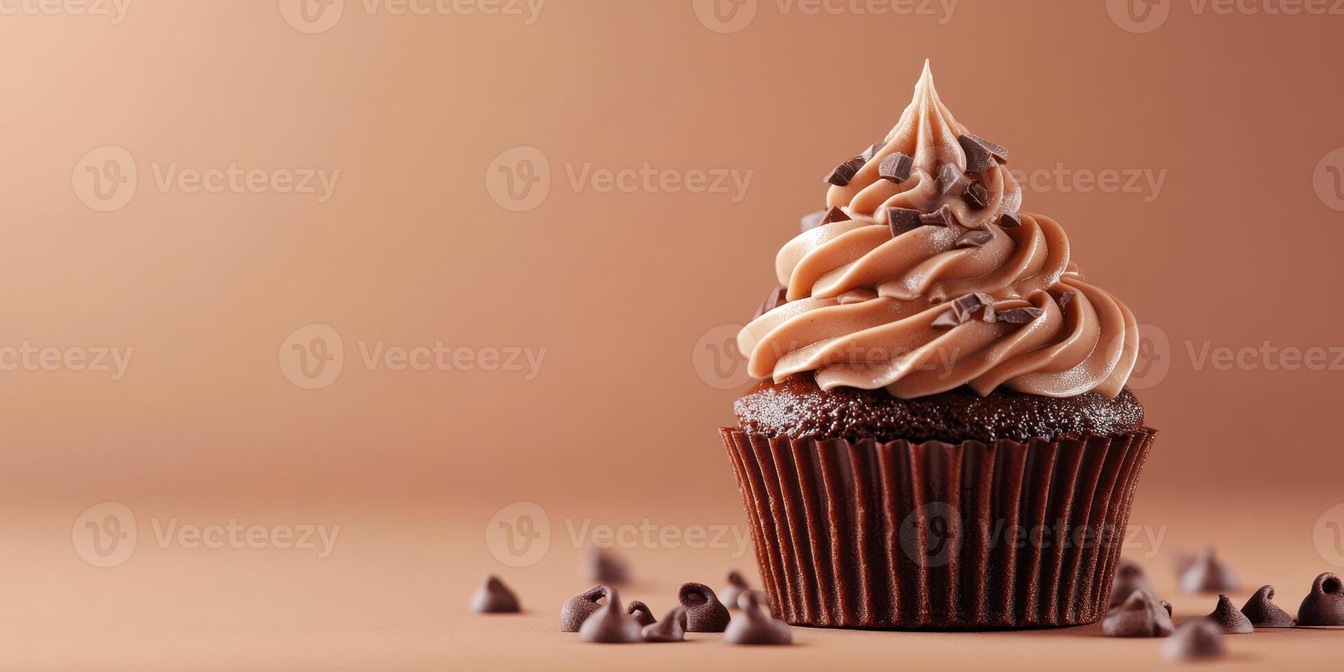 Delightful chocolate cupcake adorned with creamy frosting and chocolate chips against a warm background photo