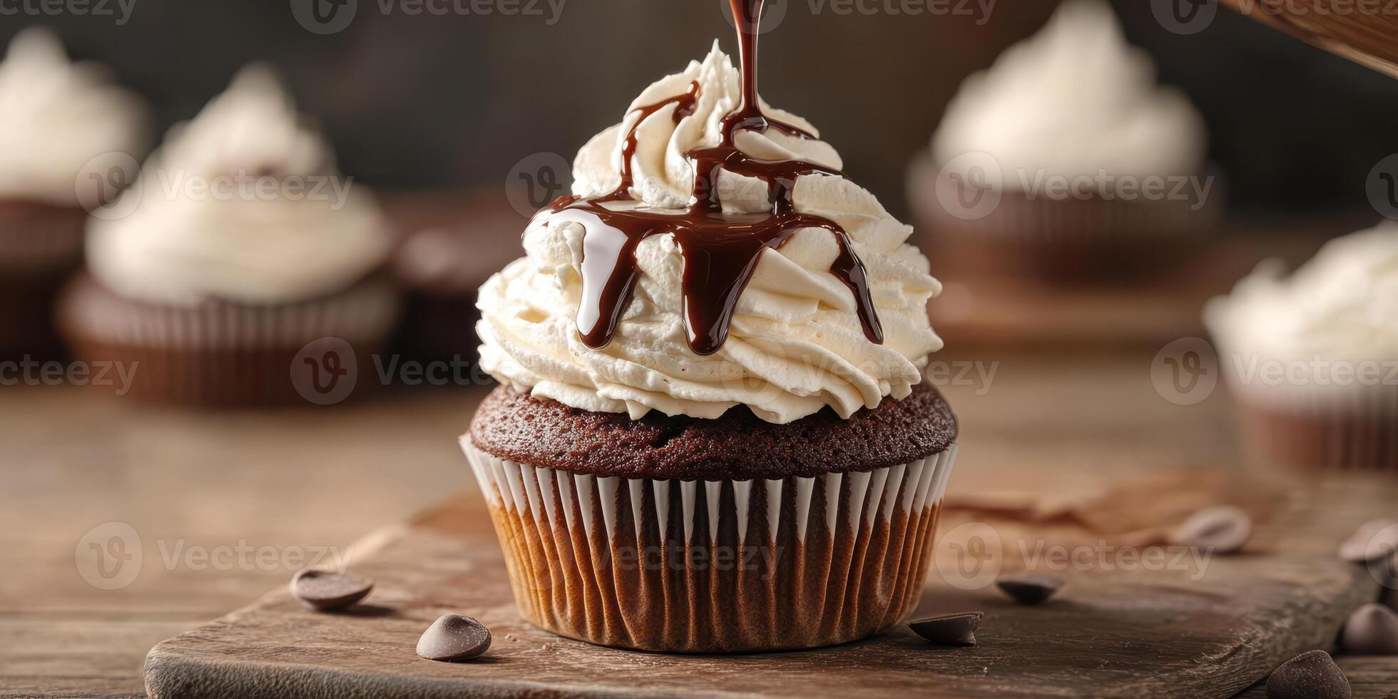 Decadent chocolate cupcake topped with whipped cream and drizzled with rich chocolate sauce photo