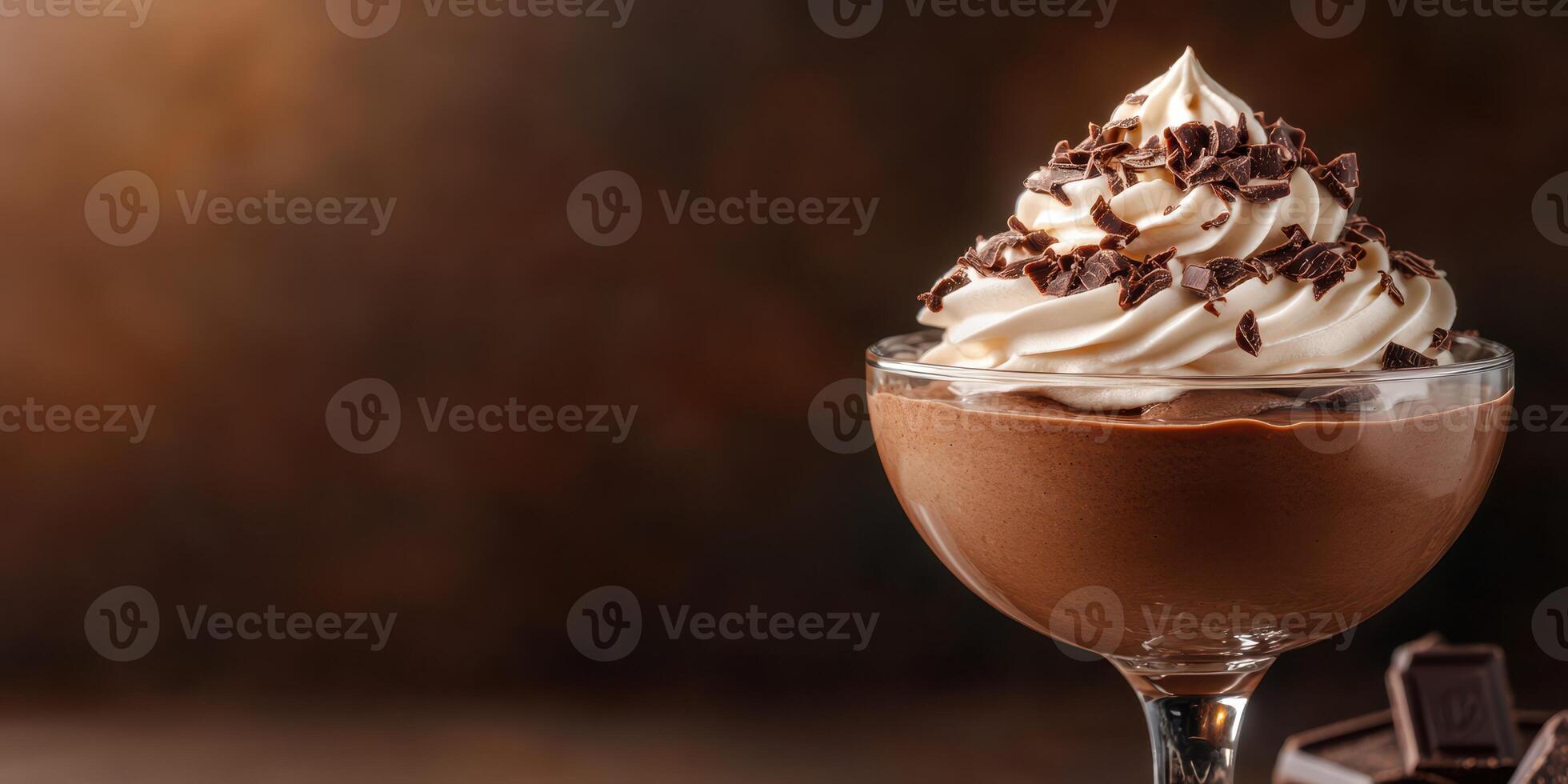 Delicious chocolate mousse topped with whipped cream and chocolate shavings photo