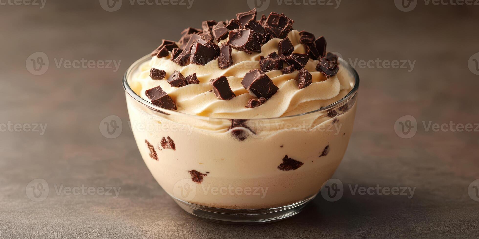 Delicious dessert featuring creamy layers and chocolate chunks in a glass bowl for a delightful treat photo