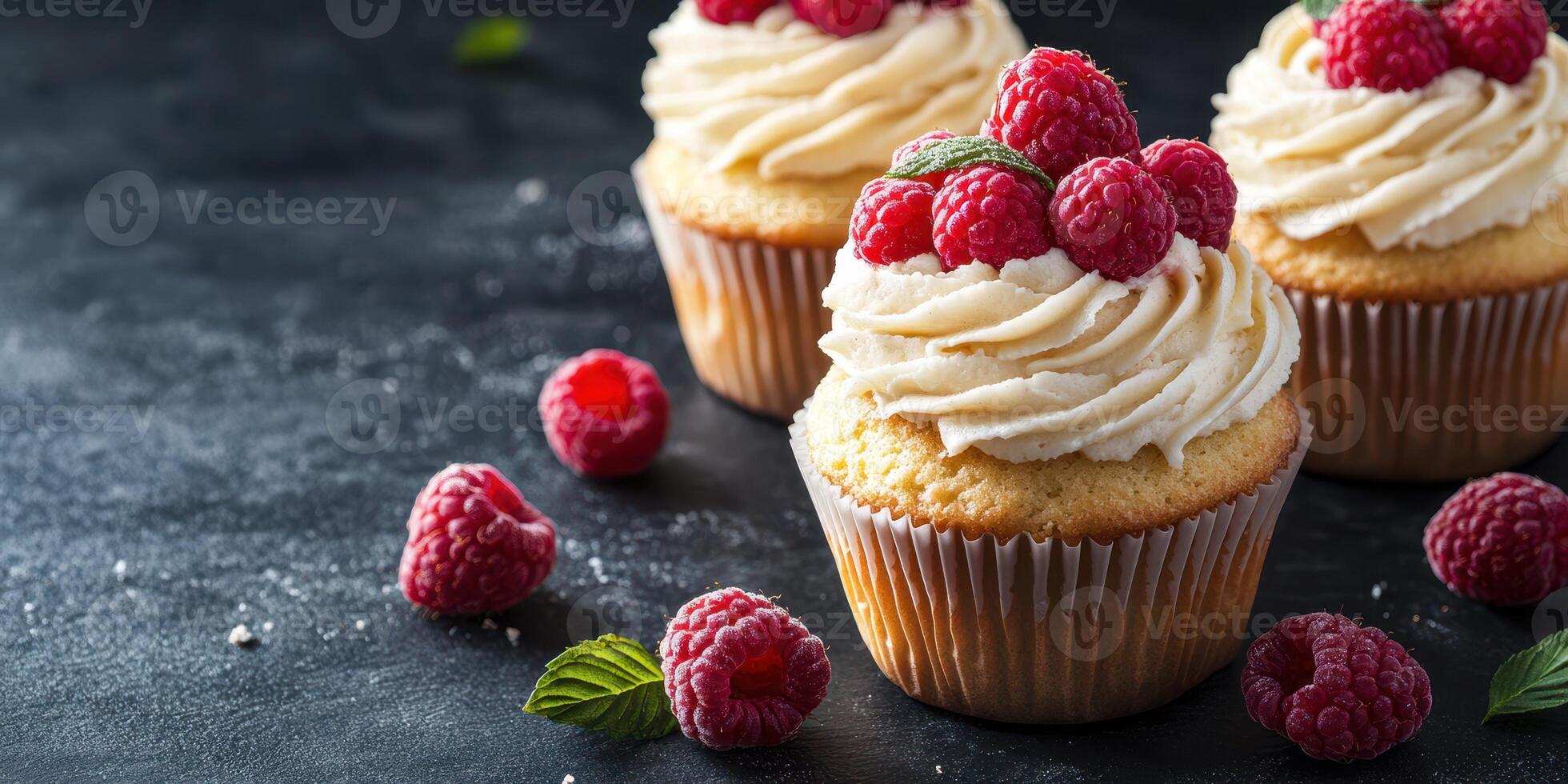 Scrumptious raspberry cupcakes with creamy frosting on a dark textured background photo