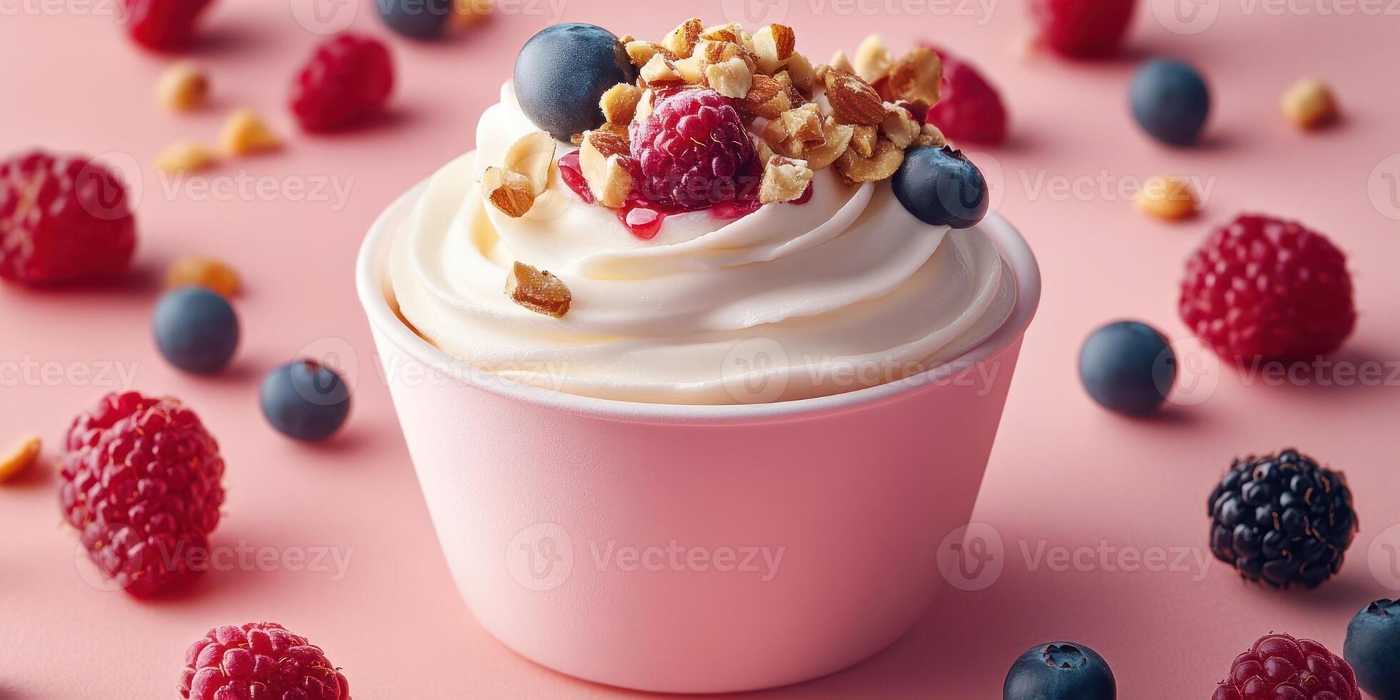 Delicious frozen yogurt topped with fresh berries and crunchy granola in a pink background setting photo