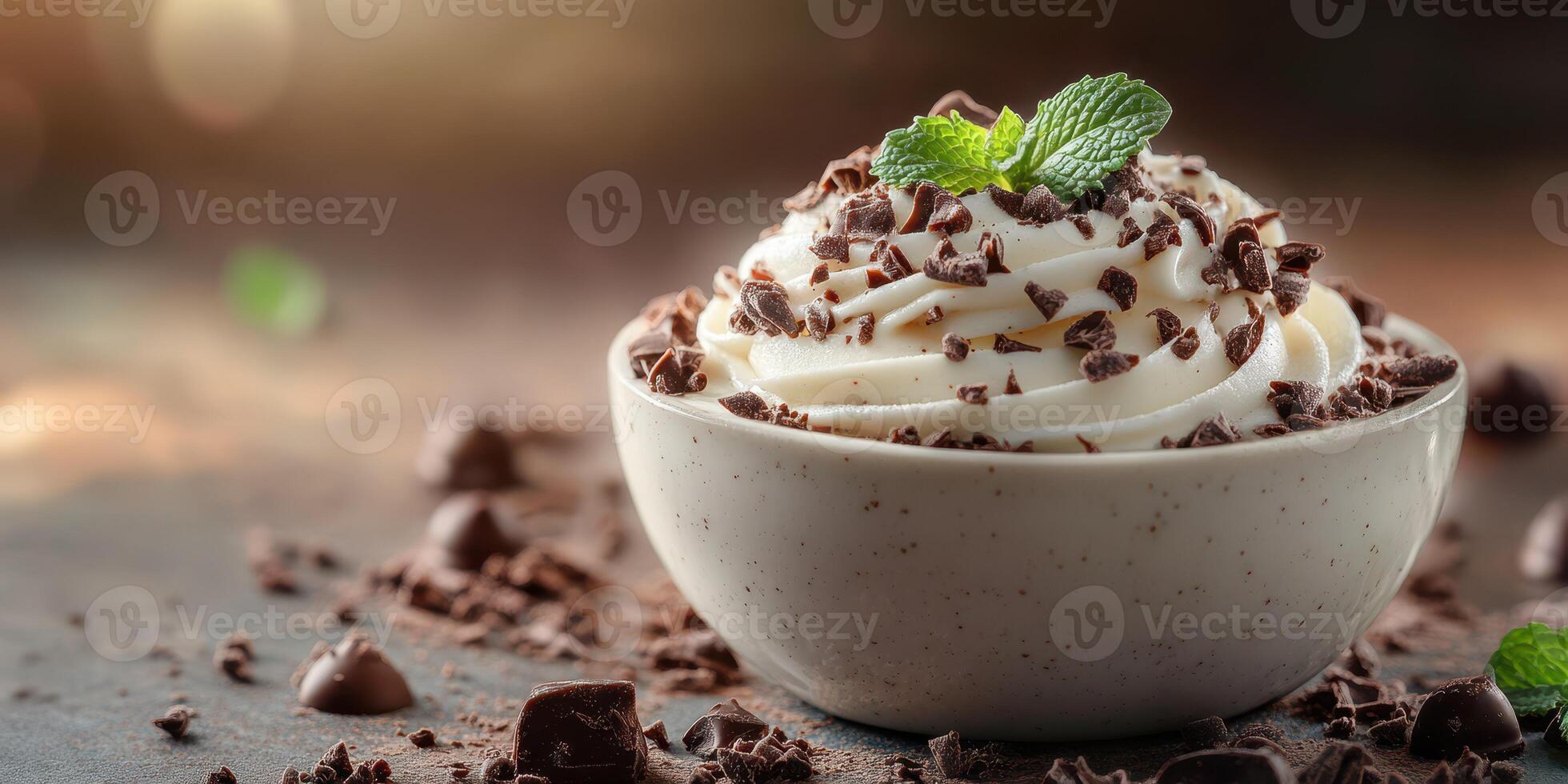 Creamy dessert topped with chocolate shavings and mint in an elegant setting photo