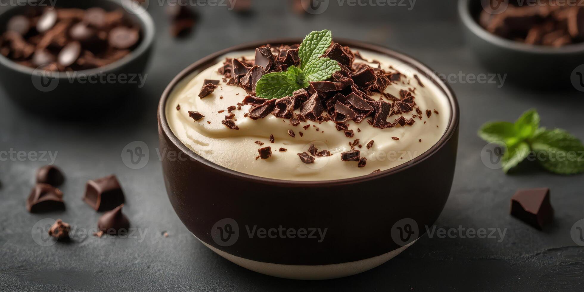 Delicious chocolate mousse with mint garnish served in a dark bowl on a table photo