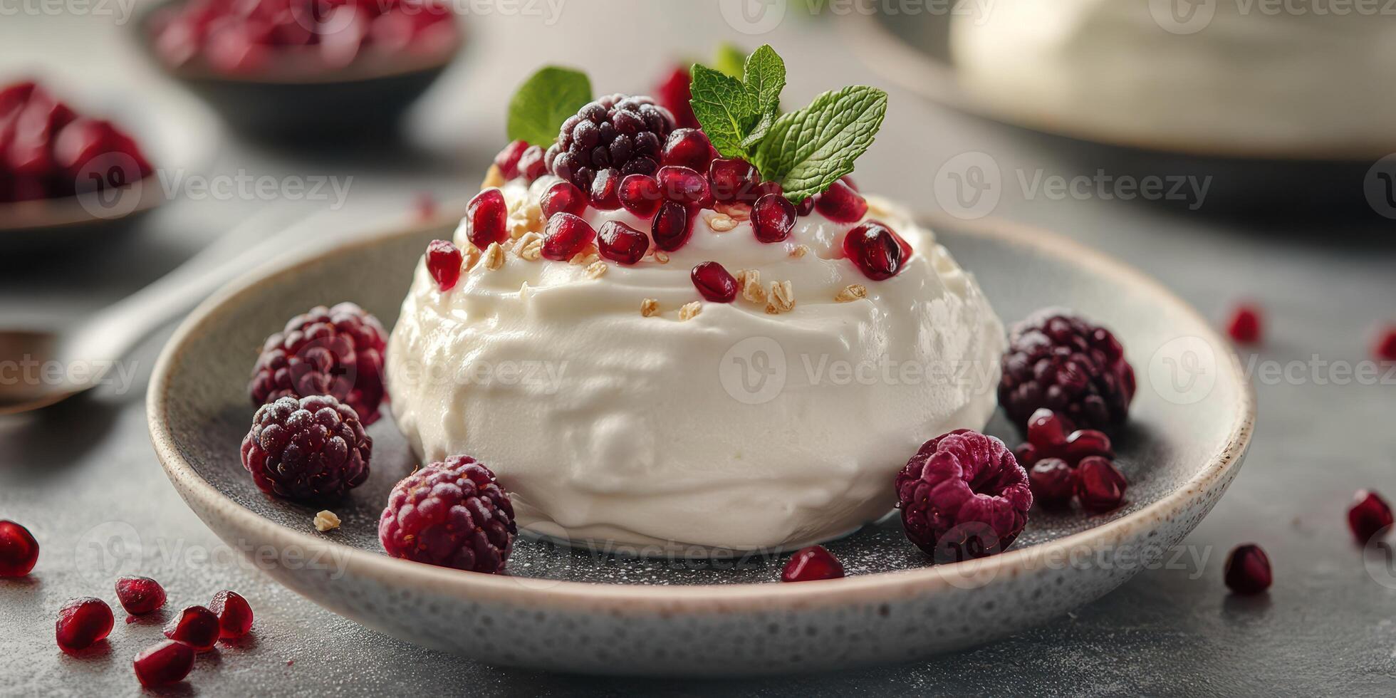 Creamy dessert with pomegranate seeds and blackberries served on a rustic plate photo